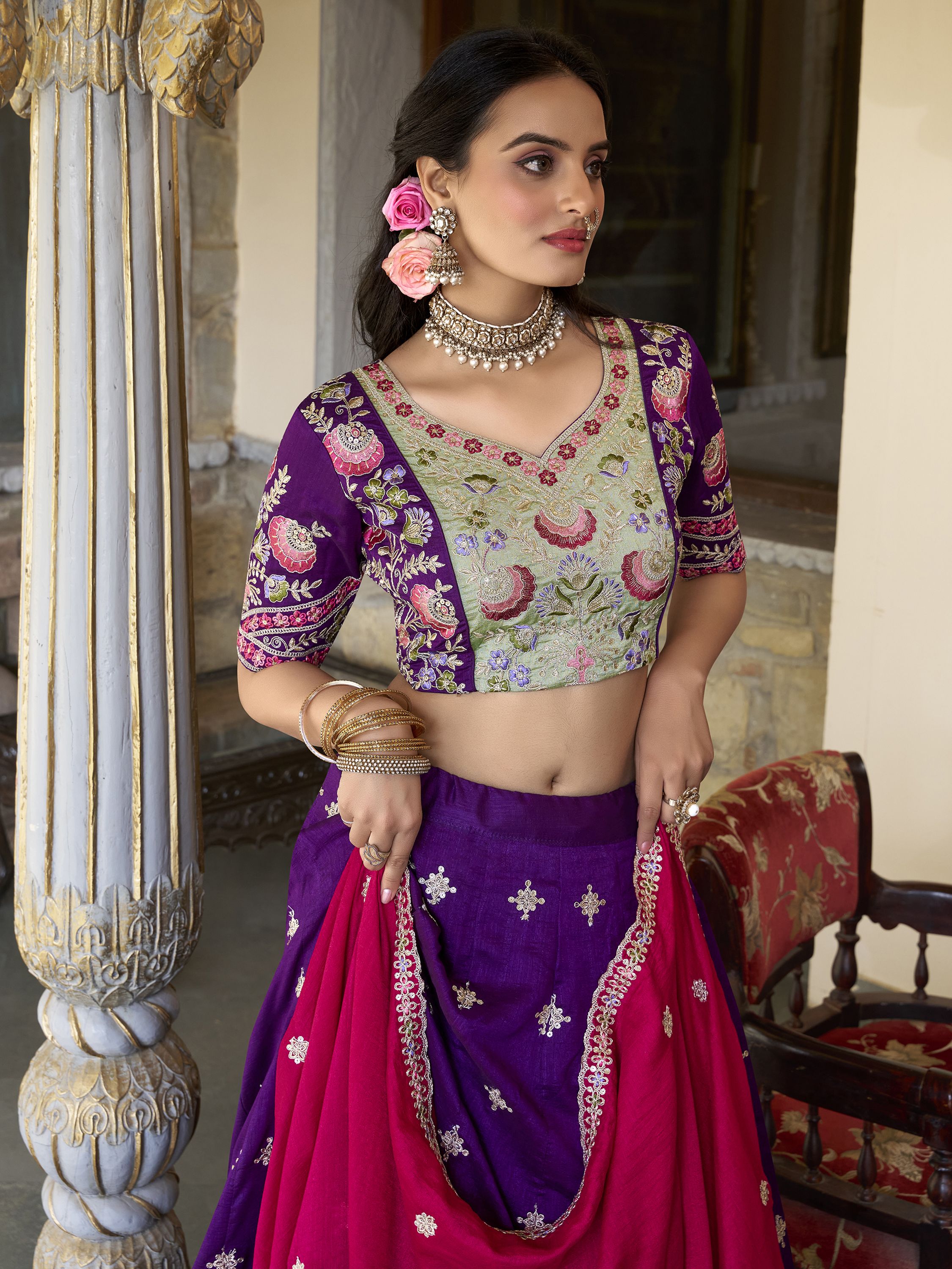 Suamya Purple Vichitra Silk Embroidered Lehenga Choli, featuring exquisite sequins and thread embroidery on luxurious Vichitra silk. The fully stitched lehenga comes with a 3-meter flair, canvas, and cancan for volume, paired with an unstitched blouse fabric for a customizable fit. The matching dupatta is adorned with sequins, embroidery, and a lace border. Perfect for weddings, festive celebrations, and grand occasions, this elegant ensemble blends sophistication with tradition
