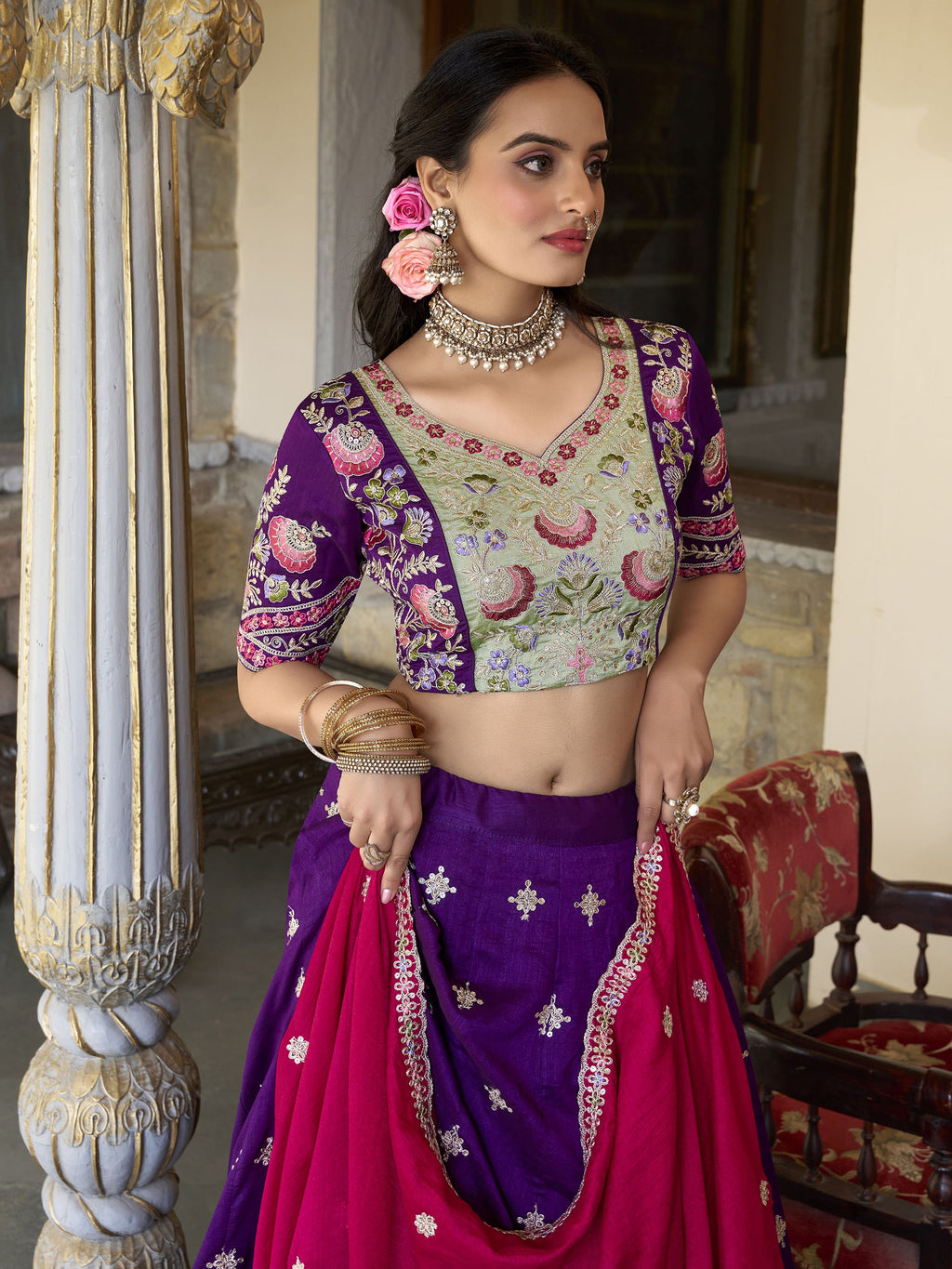Suamya Purple Vichitra Silk Embroidered Lehenga Choli, featuring exquisite sequins and thread embroidery on luxurious Vichitra silk. The fully stitched lehenga comes with a 3-meter flair, canvas, and cancan for volume, paired with an unstitched blouse fabric for a customizable fit. The matching dupatta is adorned with sequins, embroidery, and a lace border. Perfect for weddings, festive celebrations, and grand occasions, this elegant ensemble blends sophistication with tradition