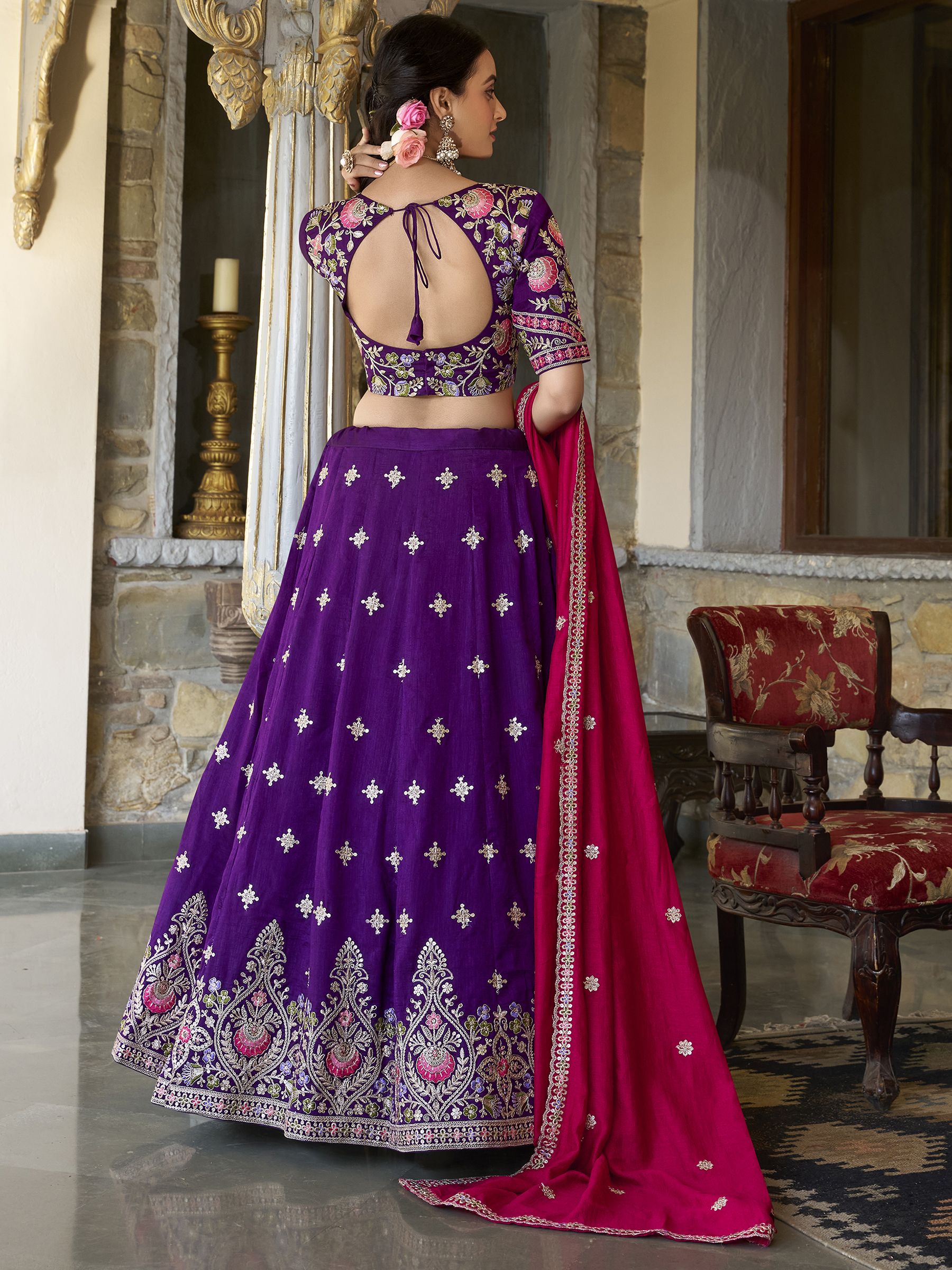 Suamya Purple Vichitra Silk Embroidered Lehenga Choli, featuring exquisite sequins and thread embroidery on luxurious Vichitra silk. The fully stitched lehenga comes with a 3-meter flair, canvas, and cancan for volume, paired with an unstitched blouse fabric for a customizable fit. The matching dupatta is adorned with sequins, embroidery, and a lace border. Perfect for weddings, festive celebrations, and grand occasions, this elegant ensemble blends sophistication with tradition