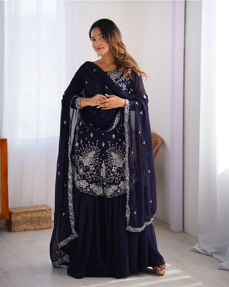 Tanvisha blue embroidered sharara suit set featuring faux georgette fabric with thread and sequin embroidery on top, sharara pants, and a dupatta with lace border – perfect for weddings, festive occasions, and luxury ethnic wear 