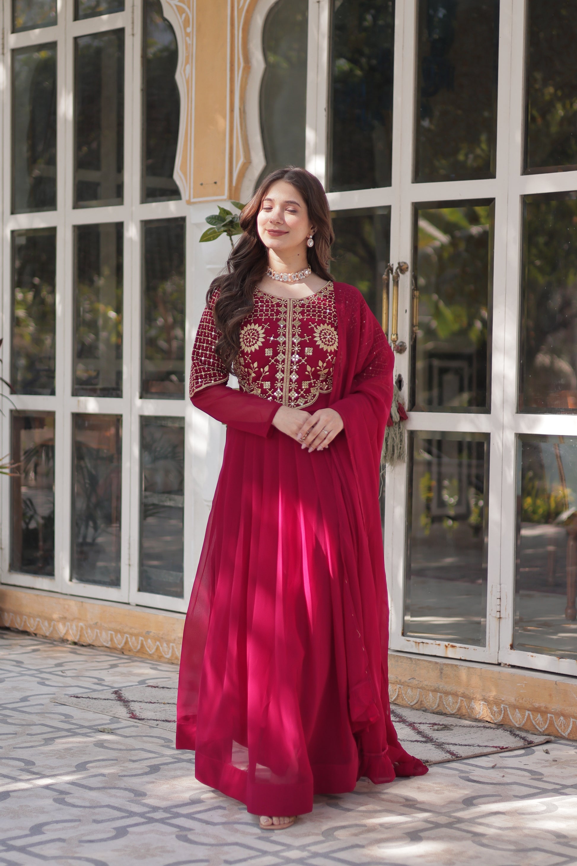 The **Tarakini Pink Embroidered Anarkali Gown Set** is a stunning blend of tradition and modern elegance, designed for grand occasions like weddings, festive celebrations, and parties. Crafted from **premium faux blooming georgette**, this **designer Anarkali gown** features intricate embroidery, a voluminous 3.5-meter flair, and a soft cotton lining for all-day comfort. 

With its **floor-length silhouette (56 inches), full sleeves, and classic round neck**, this heavy embroidered gown ensures a regal pres