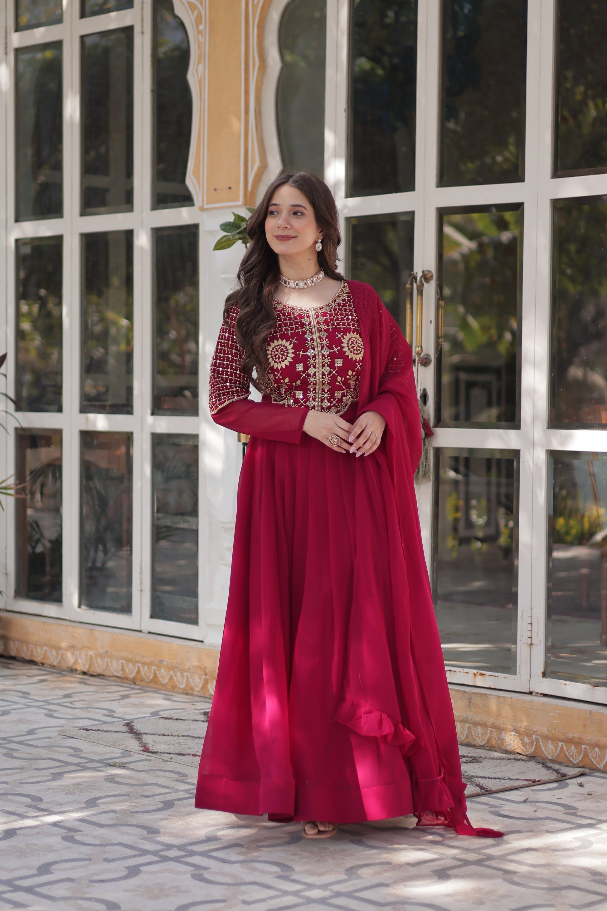 The **Tarakini Pink Embroidered Anarkali Gown Set** is a stunning blend of tradition and modern elegance, designed for grand occasions like weddings, festive celebrations, and parties. Crafted from **premium faux blooming georgette**, this **designer Anarkali gown** features intricate embroidery, a voluminous 3.5-meter flair, and a soft cotton lining for all-day comfort. 

With its **floor-length silhouette (56 inches), full sleeves, and classic round neck**, this heavy embroidered gown ensures a regal pres