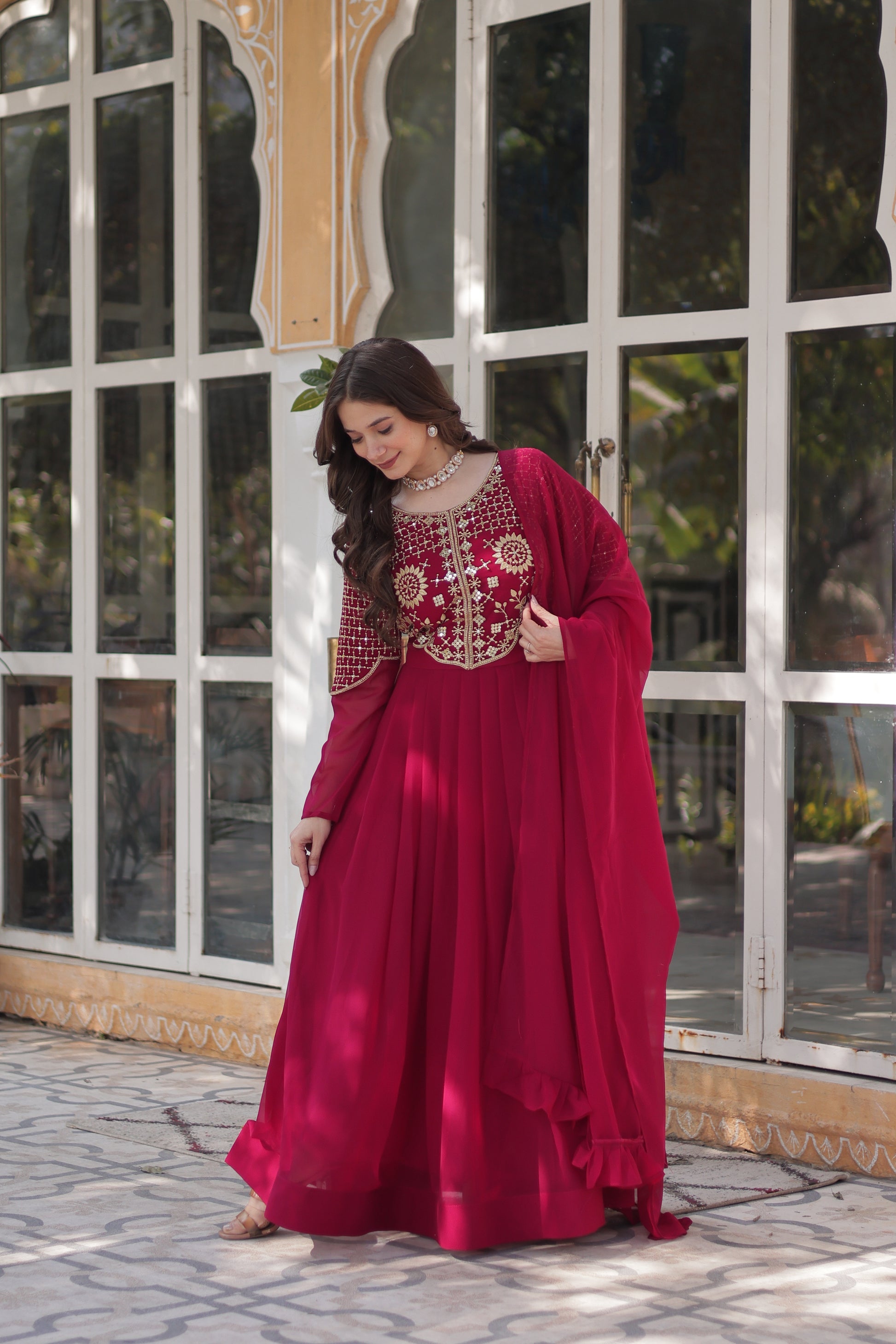 The **Tarakini Pink Embroidered Anarkali Gown Set** is a stunning blend of tradition and modern elegance, designed for grand occasions like weddings, festive celebrations, and parties. Crafted from **premium faux blooming georgette**, this **designer Anarkali gown** features intricate embroidery, a voluminous 3.5-meter flair, and a soft cotton lining for all-day comfort. 

With its **floor-length silhouette (56 inches), full sleeves, and classic round neck**, this heavy embroidered gown ensures a regal pres