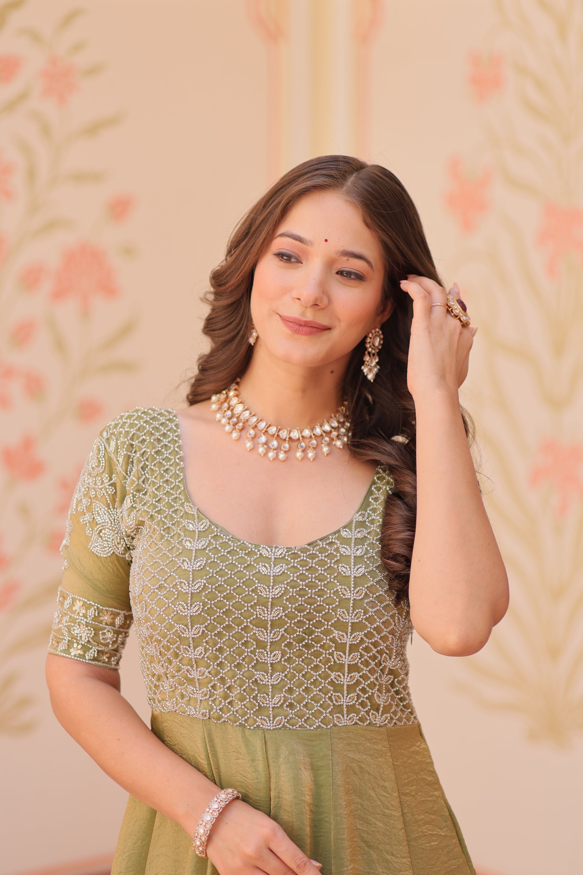 Vaibhavi Pista Green Gown in Fendy Silk with beads embroidery, 3.5m flair & boat neck – a graceful, fully-stitched festive outfit.