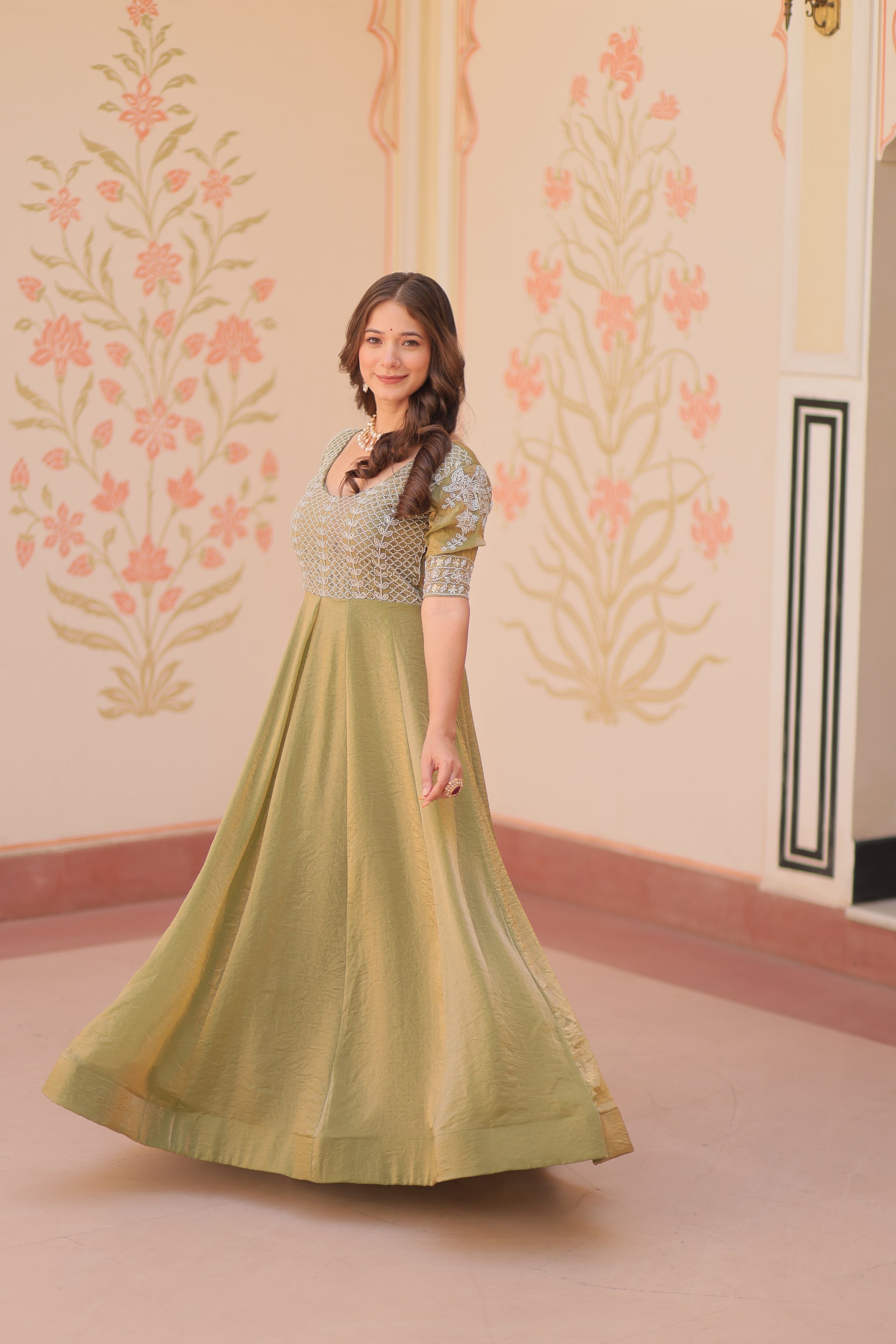 Vaibhavi Pista Green Gown in Fendy Silk with beads embroidery, 3.5m flair & boat neck – a graceful, fully-stitched festive outfit.