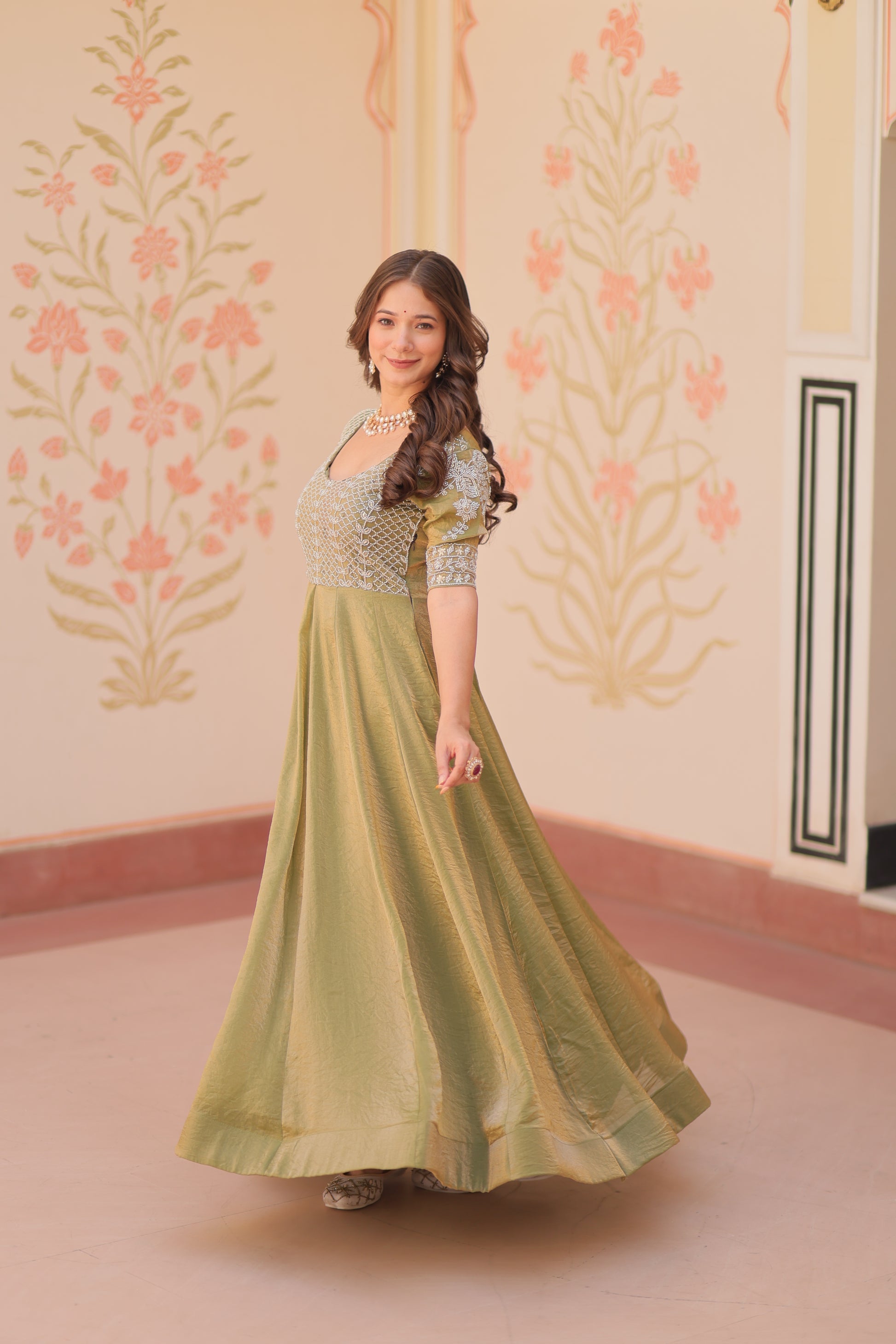 Vaibhavi Pista Green Gown in Fendy Silk with beads embroidery, 3.5m flair & boat neck – a graceful, fully-stitched festive outfit.