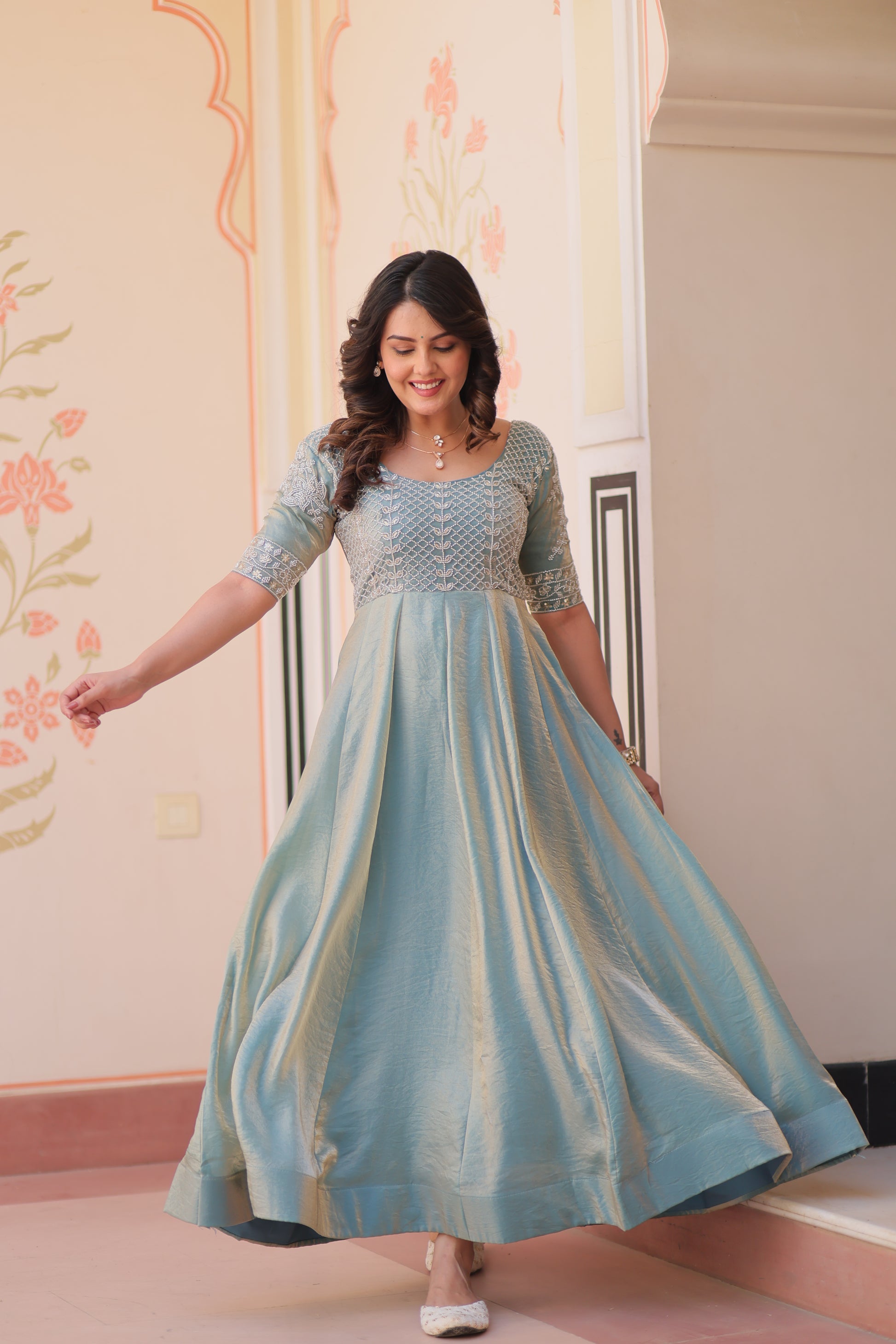 Vaibhavi Sky Blue Gown in Fendy Silk with beads embroidery, 3.5m flair & boat neck – fully stitched elegance for festive occasions.