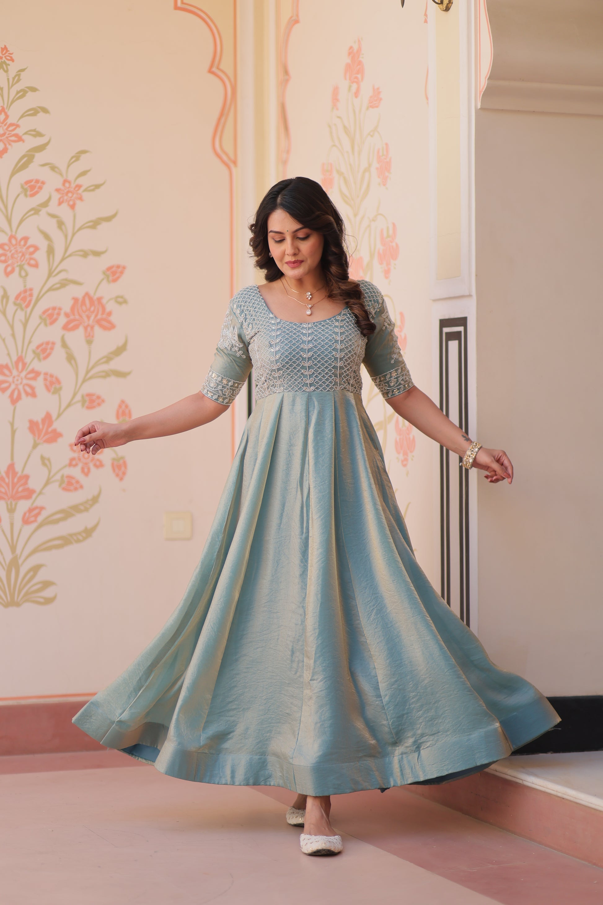 Vaibhavi Sky Blue Gown in Fendy Silk with beads embroidery, 3.5m flair & boat neck – fully stitched elegance for festive occasions.