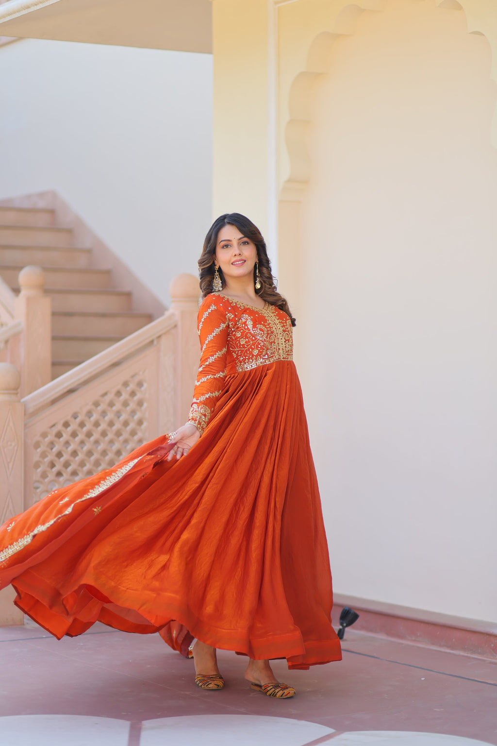 Varnita Orange Gown in Fendy Silk with zari & sequin work, full sleeves, V-neck & dupatta – regal festive wear, fully stitched.