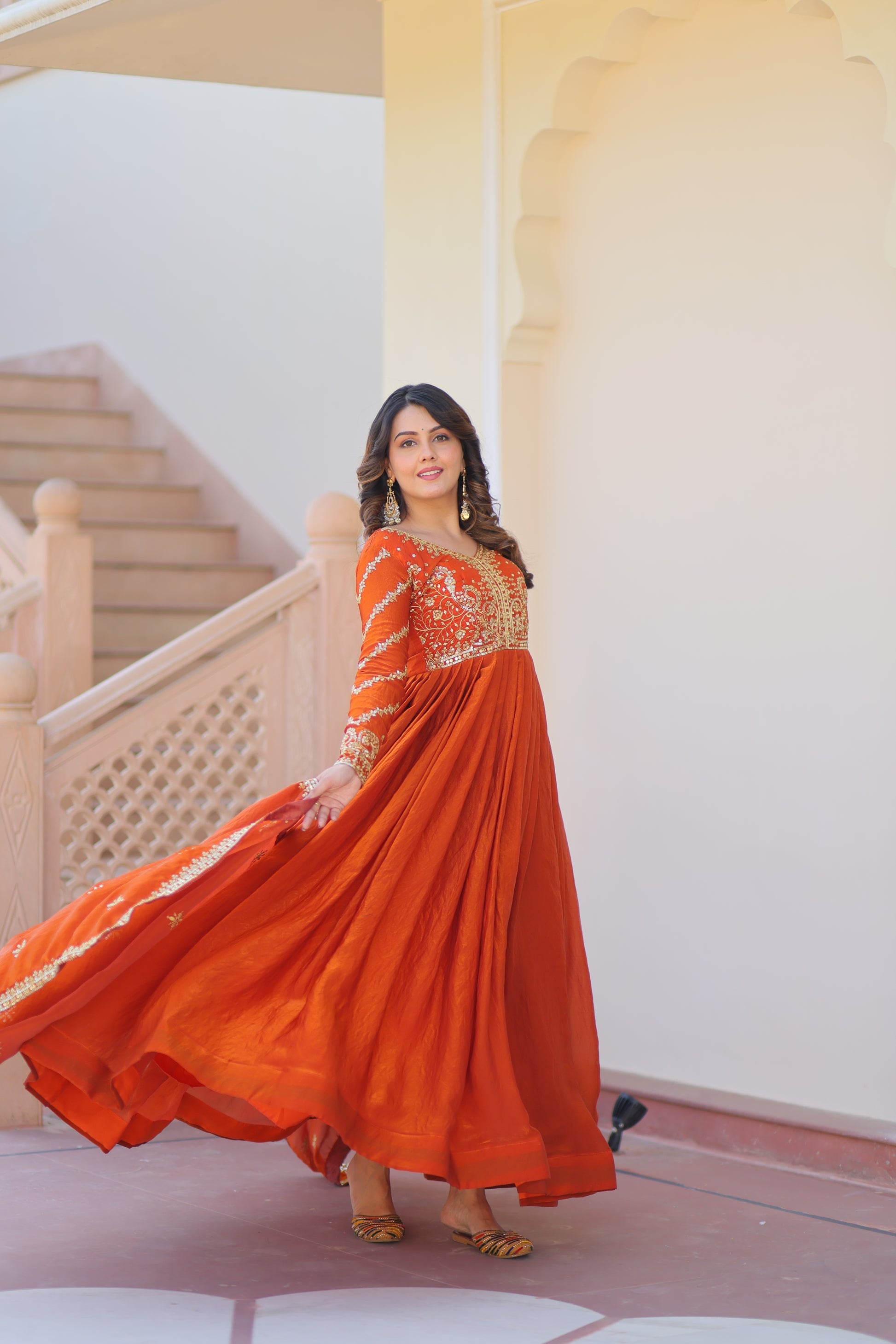 Varnita Orange Gown in Fendy Silk with zari & sequin work, full sleeves, V-neck & dupatta – regal festive wear, fully stitched.