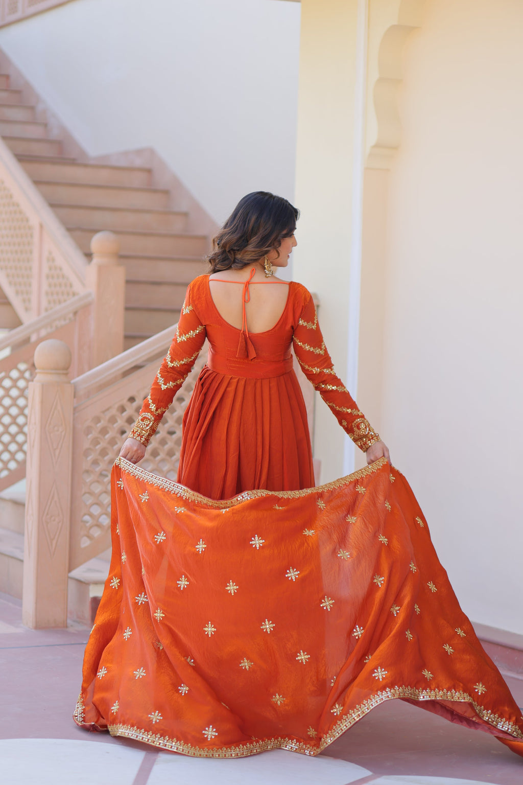 Varnita Orange Gown in Fendy Silk with zari & sequin work, full sleeves, V-neck & dupatta – regal festive wear, fully stitched.