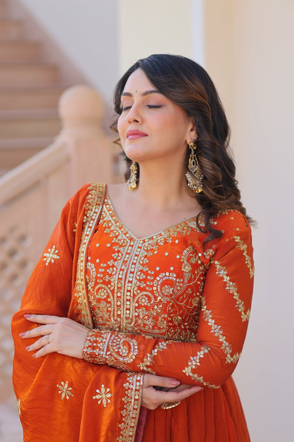Varnita Orange Gown in Fendy Silk with zari & sequin work, full sleeves, V-neck & dupatta – regal festive wear, fully stitched.
