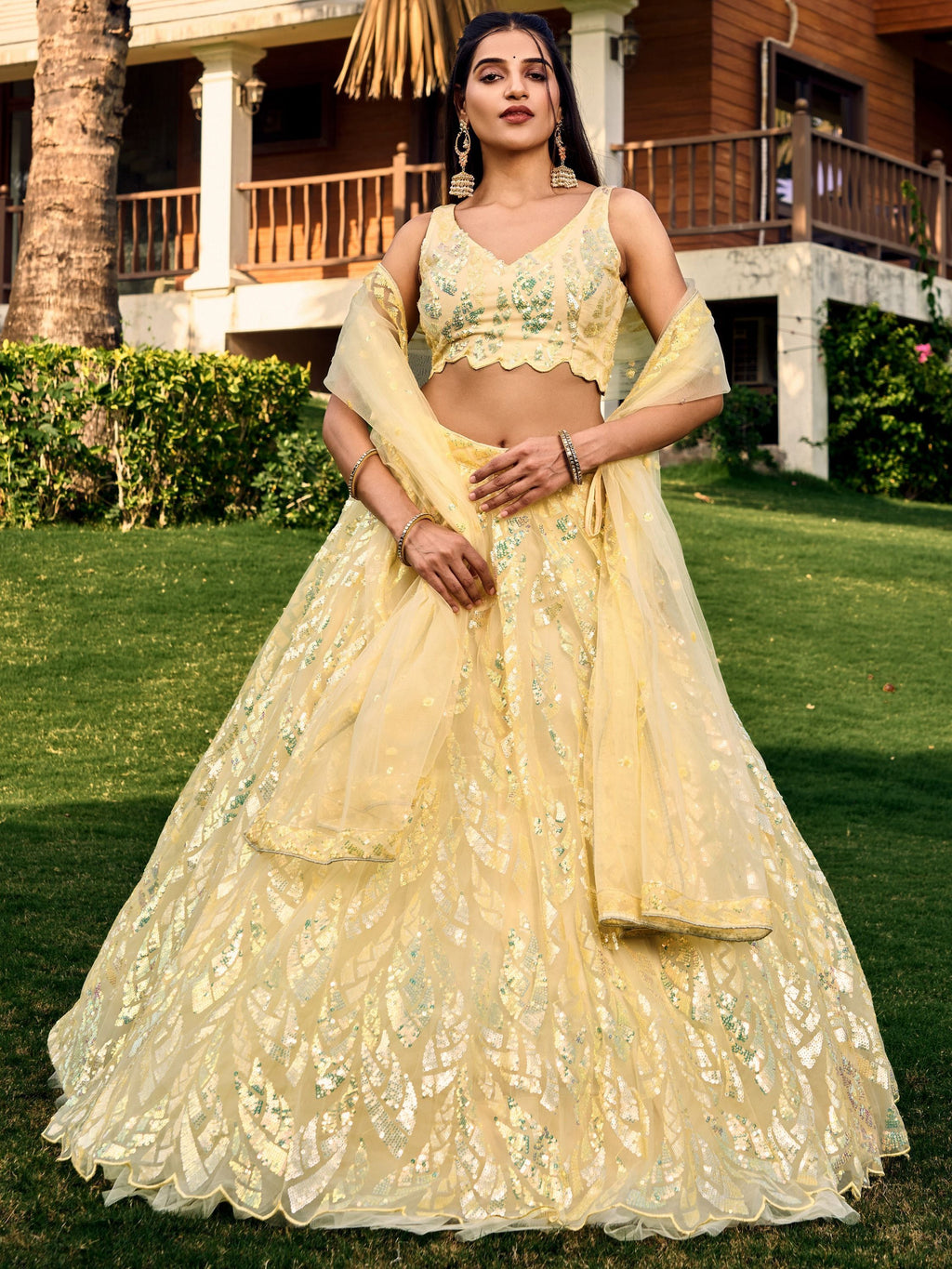 Yellow net sequins embroidered party wear lehenga choli