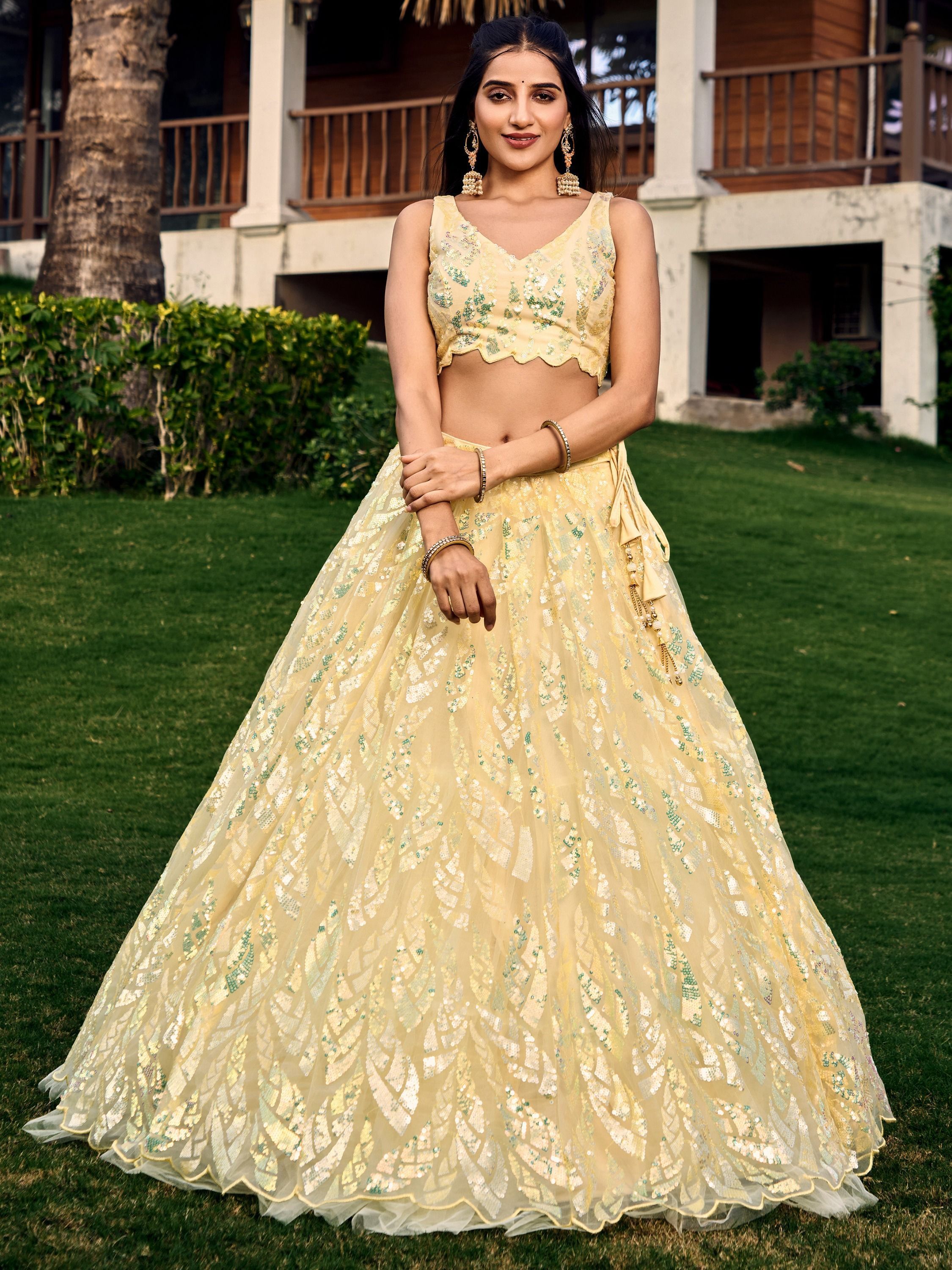 Yellow net sequins embroidered party wear lehenga choli