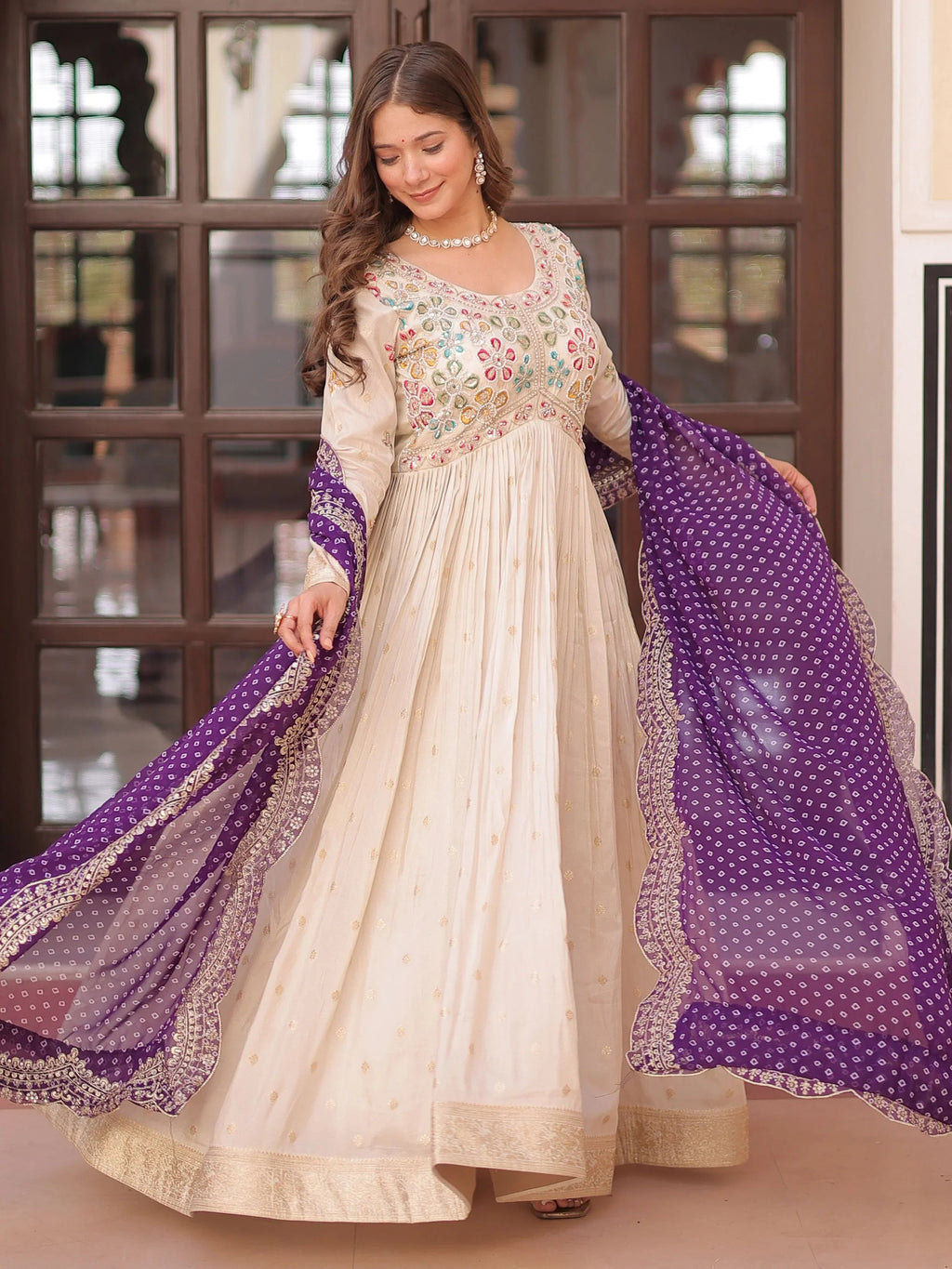 Cream silk gown with pearl beads embroidery and purple bandhani dupatta