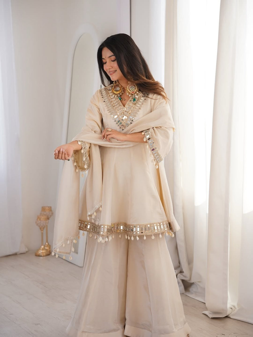 Ivory Luxe Mirror Work Sharara Set with Intricate Embroidered Neckline, Statement Sleeve Detailing & Pearl Tassel Dupatta