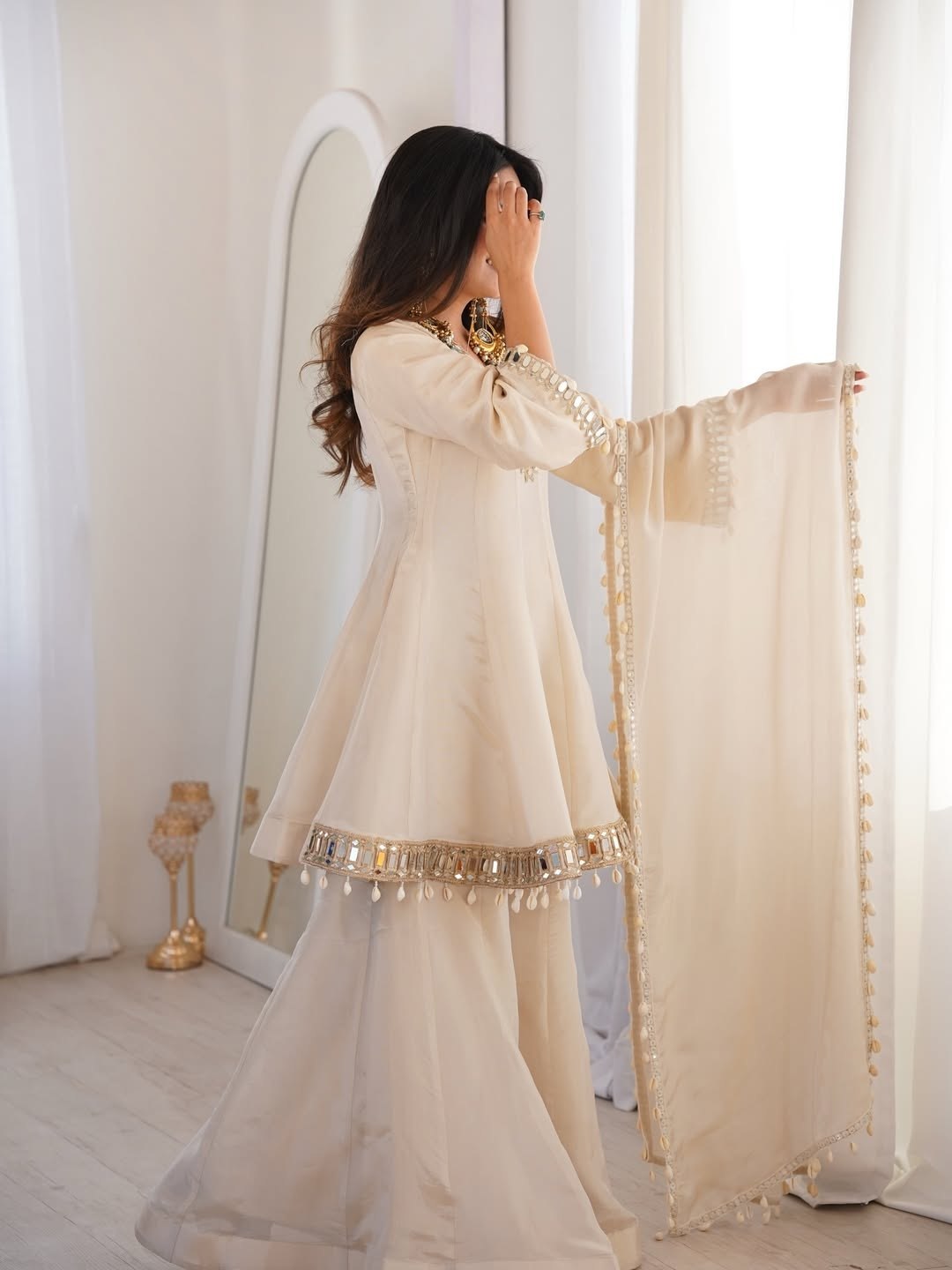 Ivory Luxe Mirror Work Sharara Set with Intricate Embroidered Neckline, Statement Sleeve Detailing & Pearl Tassel Dupatta