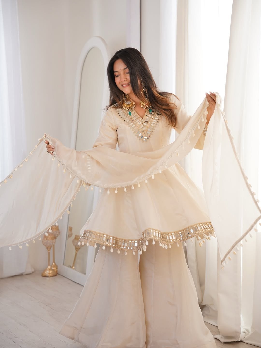 Ivory Luxe Mirror Work Sharara Set with Intricate Embroidered Neckline, Statement Sleeve Detailing & Pearl Tassel Dupatta