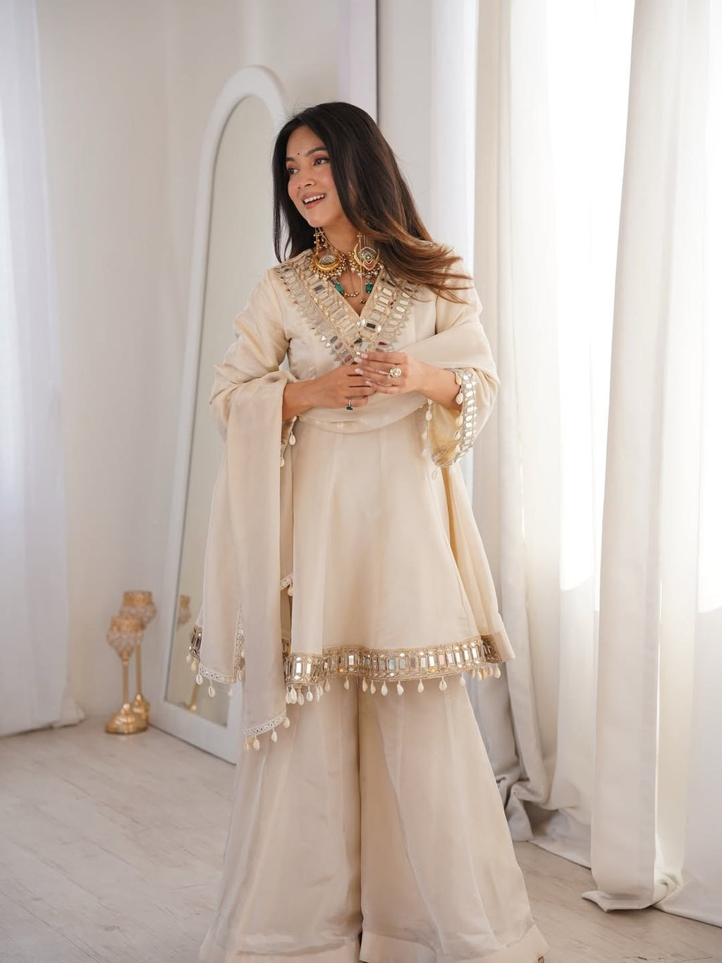 Ivory Luxe Mirror Work Sharara Set with Intricate Embroidered Neckline, Statement Sleeve Detailing & Pearl Tassel Dupatta