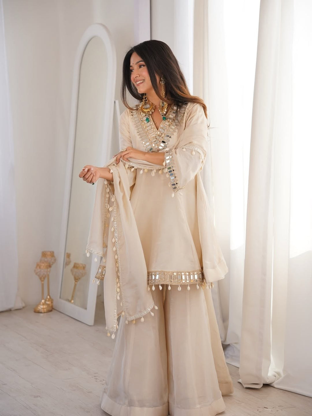 Ivory Luxe Mirror Work Sharara Set with Intricate Embroidered Neckline, Statement Sleeve Detailing & Pearl Tassel Dupatta