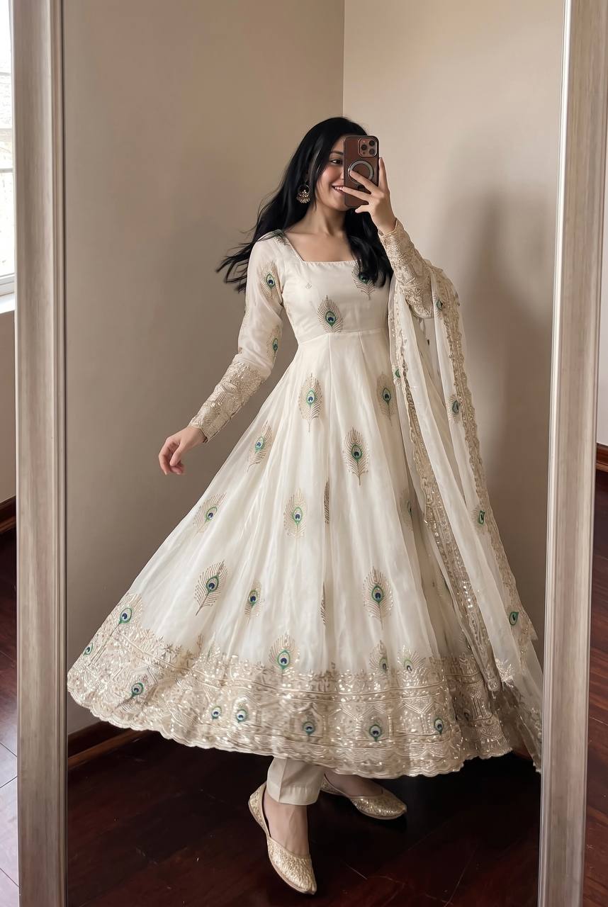 Ivory Peacock Motif Anarkali Set – A Graceful Flared Silhouette Adorned with Delicate Peacock Motifs, Intricate Gold Embroidery, Ornate Hem Border and a Matching Embroidered Dupatta.