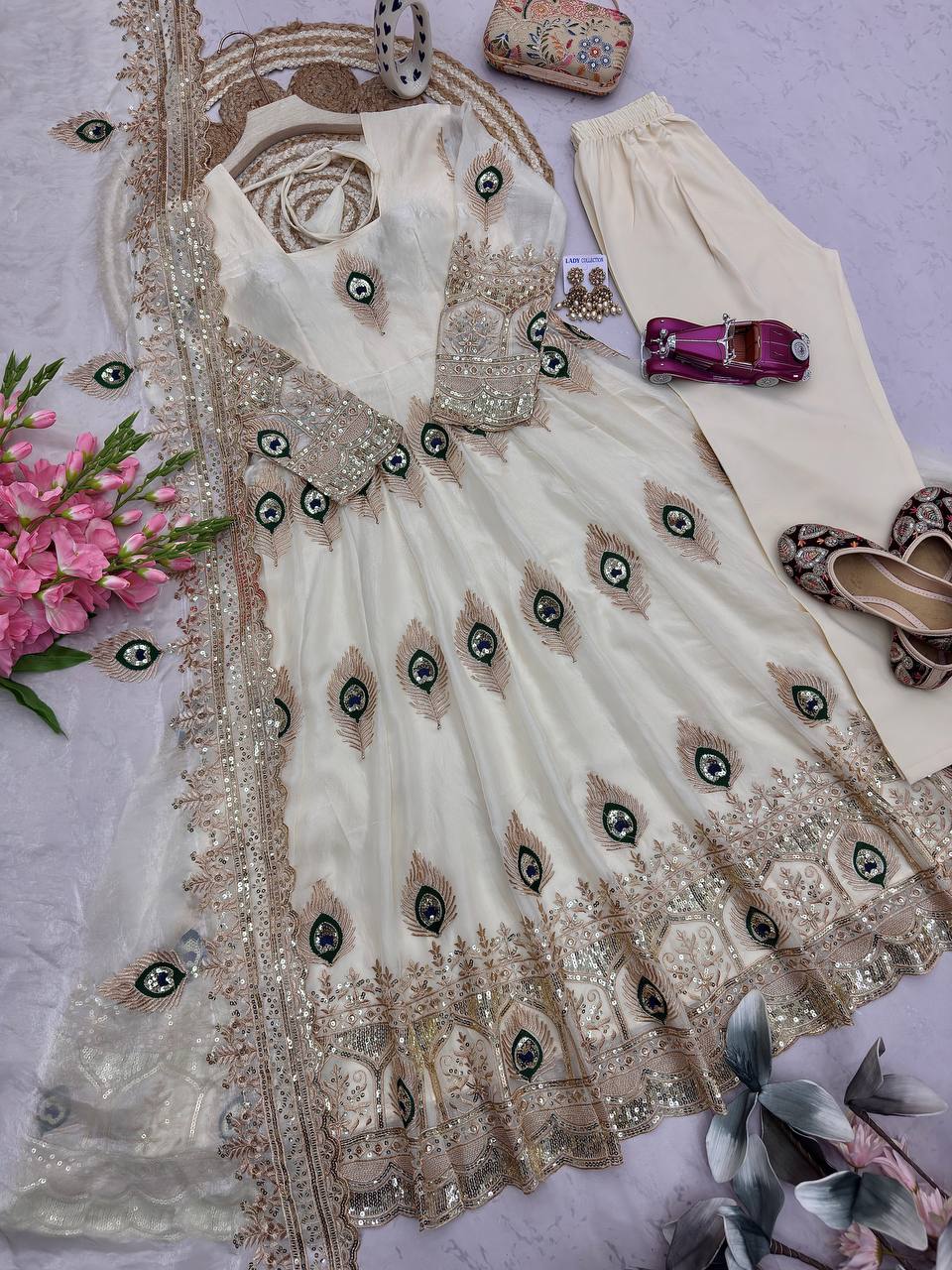 Ivory Peacock Motif Anarkali Set – A Graceful Flared Silhouette Adorned with Delicate Peacock Motifs, Intricate Gold Embroidery, Ornate Hem Border and a Matching Embroidered Dupatta.