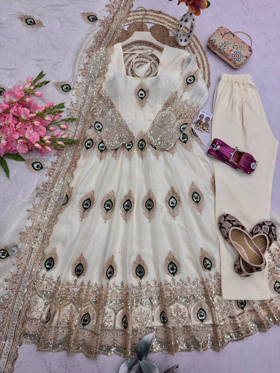 Ivory Peacock Motif Anarkali Set – A Graceful Flared Silhouette Adorned with Delicate Peacock Motifs, Intricate Gold Embroidery, Ornate Hem Border and a Matching Embroidered Dupatta.