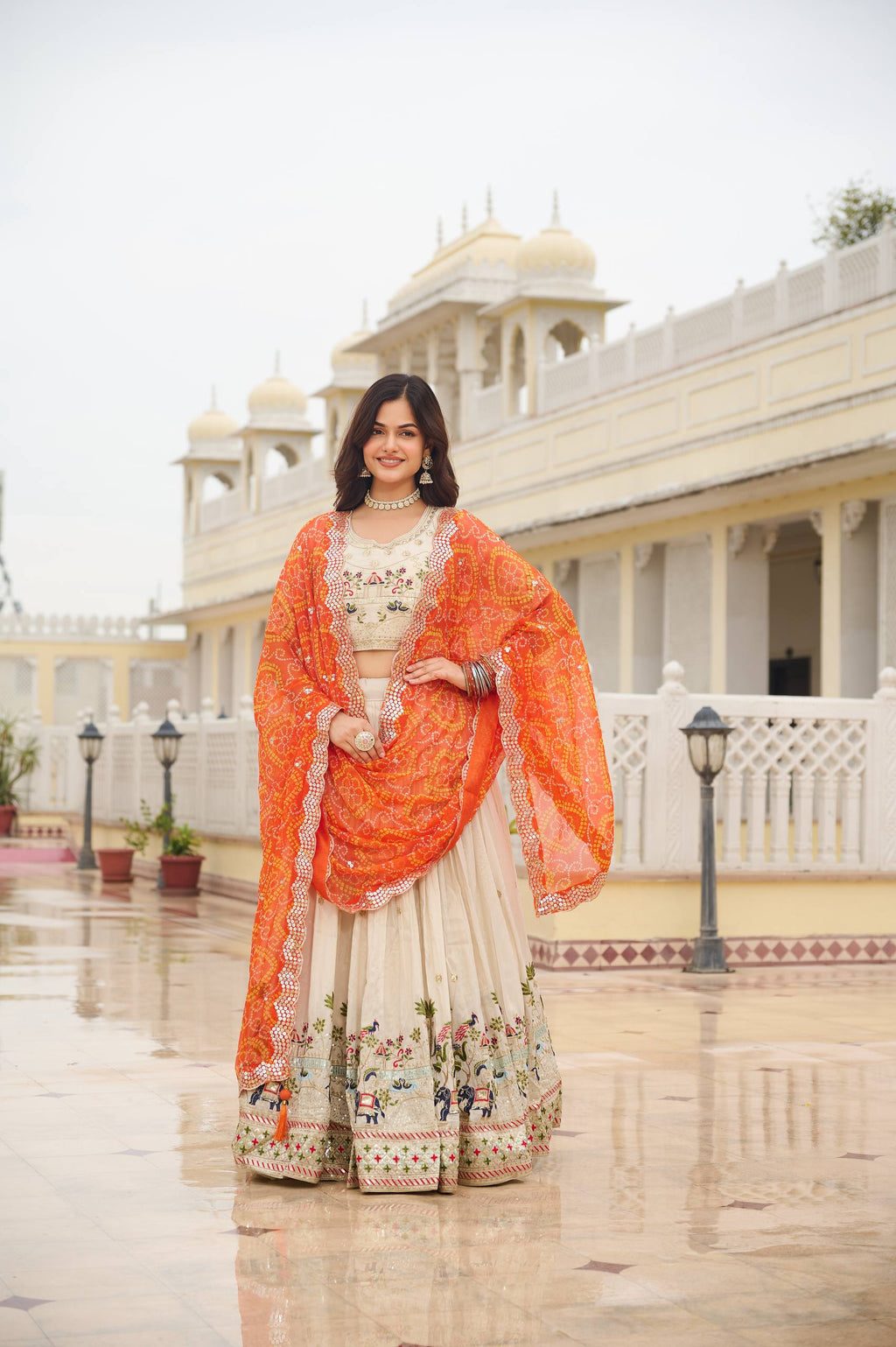 Off-white silk sequins thread embroidery lehenga choli with orange Bandhej dupatta