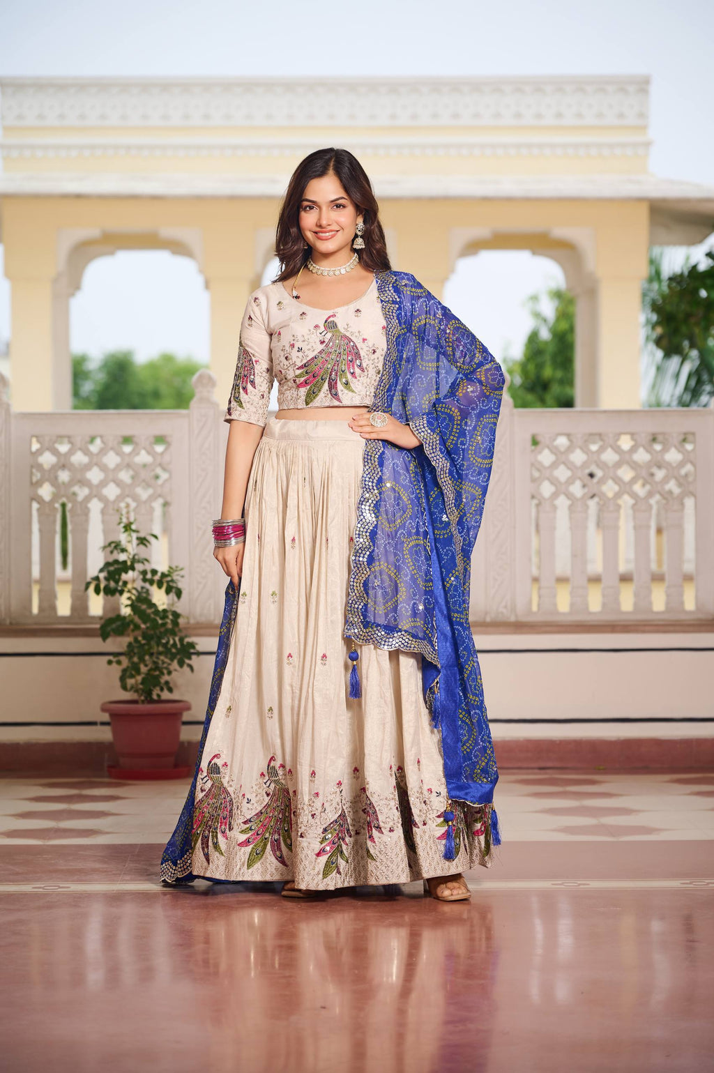 Amla off-white tissue silk lehenga choli with sequins thread work and blue Bandhej dupatta