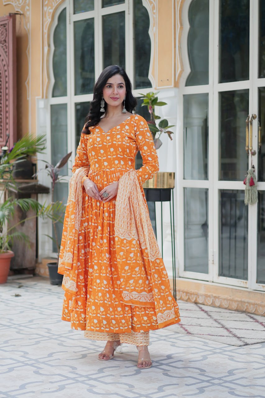 The Ridhvini Orange Pure Cotton Printed Anarkali Set is a stylish and breathable cotton Anarkali suit for women, perfect for daily wear, office wear, and festive occasions. Made from premium pure cotton, this readymade Anarkali kurta set offers comfort and elegance with a flowing silhouette, fancy V-neck, and full sleeves. Paired with straight cotton pants and a matching dupatta, this ethnic cotton suit is ideal for summer fashion. Whether you're looking for a lightweight festive outfit or a printed Anarkal