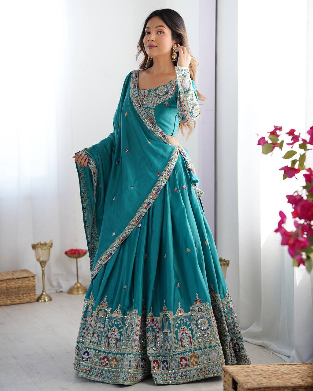Kavyani Natural Crepe Silk Teal Color Lehenga Choli Set – semi-stitched lehenga with 3-meter flair, cancan and canvas patta, intricately embroidered with coding dori, thread, and sequins; paired with unstitched matching choli and embroidered dupatta with lace border, premium festive and wedding ethnic wear for women by Trinaari.