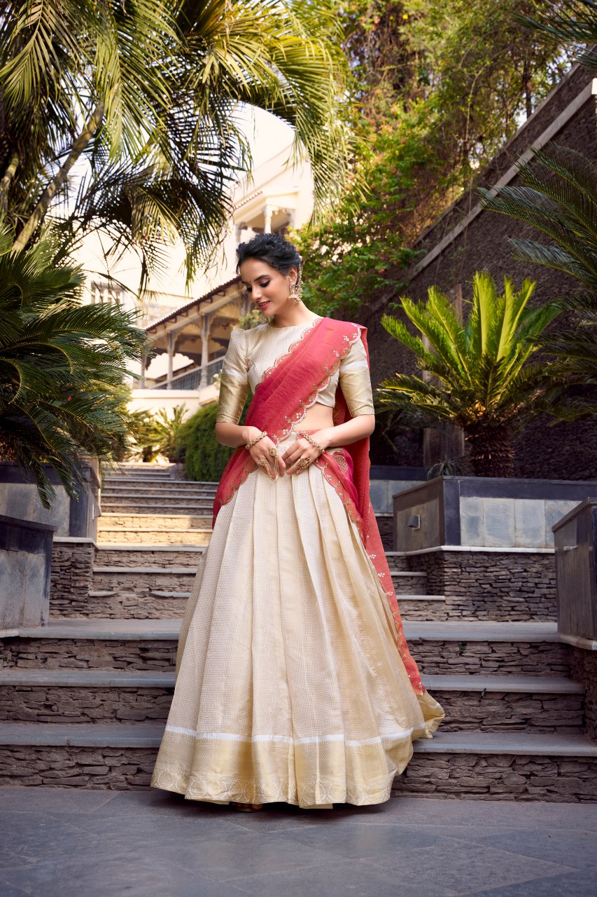 Off-white Jacquard Chex lehenga choli with intricate zari weaving, 4-meter flair, paired with shimmer dupatta featuring sequin and thread embroidery – perfect for weddings and festive celebrations.