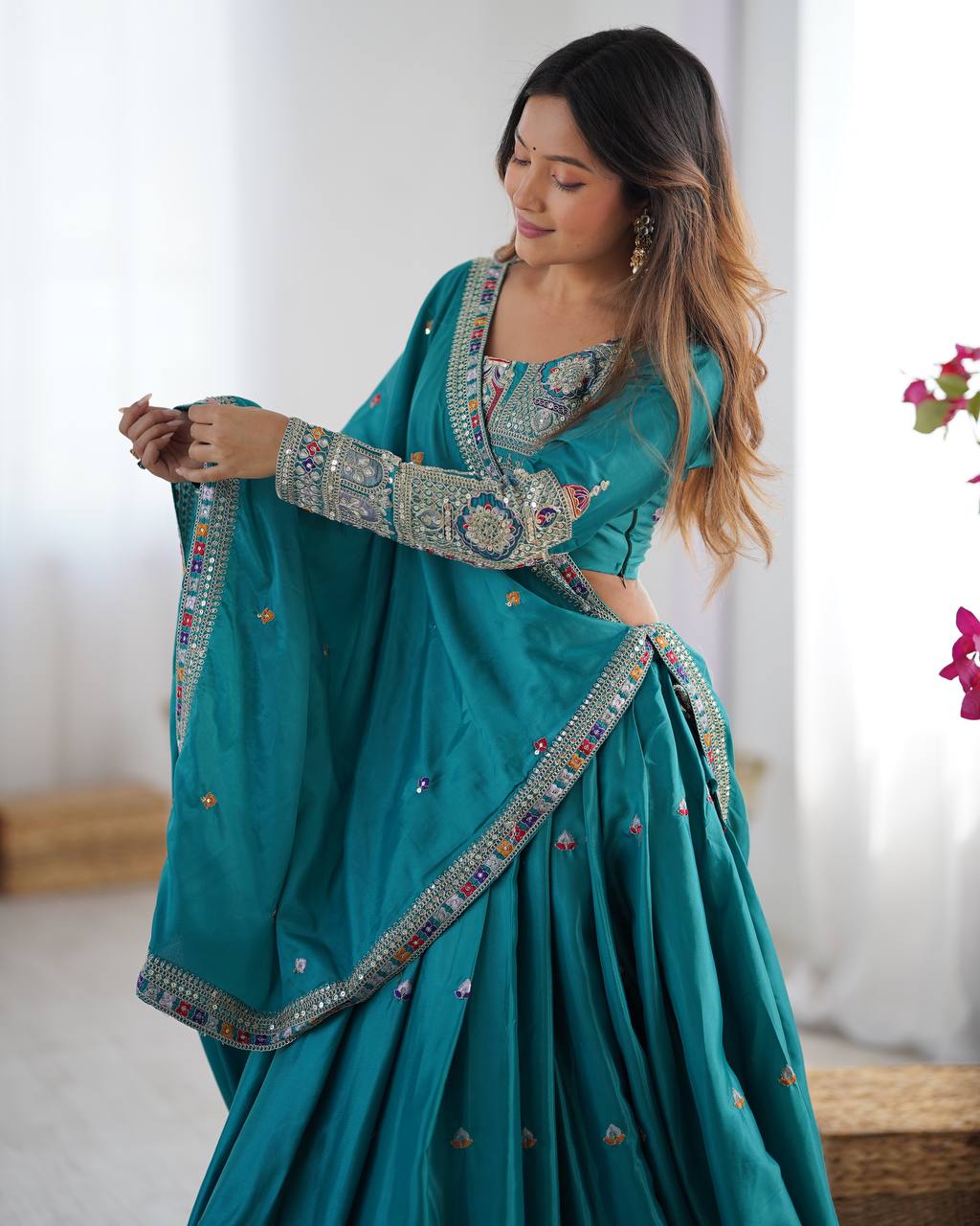 Kavyani Natural Crepe Silk Teal Color Lehenga Choli Set – semi-stitched lehenga with 3-meter flair, cancan and canvas patta, intricately embroidered with coding dori, thread, and sequins; paired with unstitched matching choli and embroidered dupatta with lace border, premium festive and wedding ethnic wear for women by Trinaari.