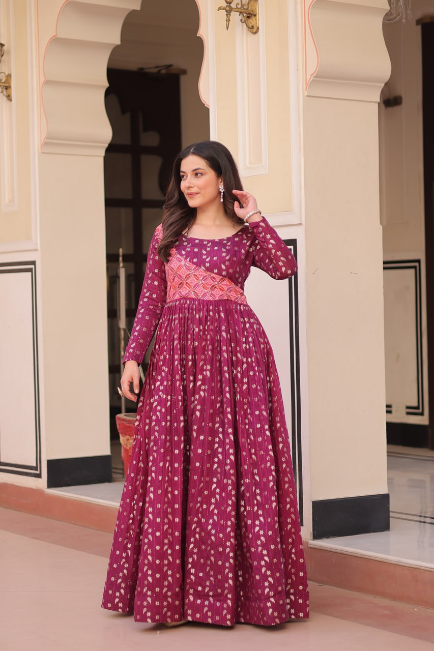 Vani Choli Printed Wine Color Gown with staple jacquard fabric, full sleeves, cotton lining, and 3-meter flare – perfect ethnic party wear gown for wedding functions, festive nights, and modern Indian women.