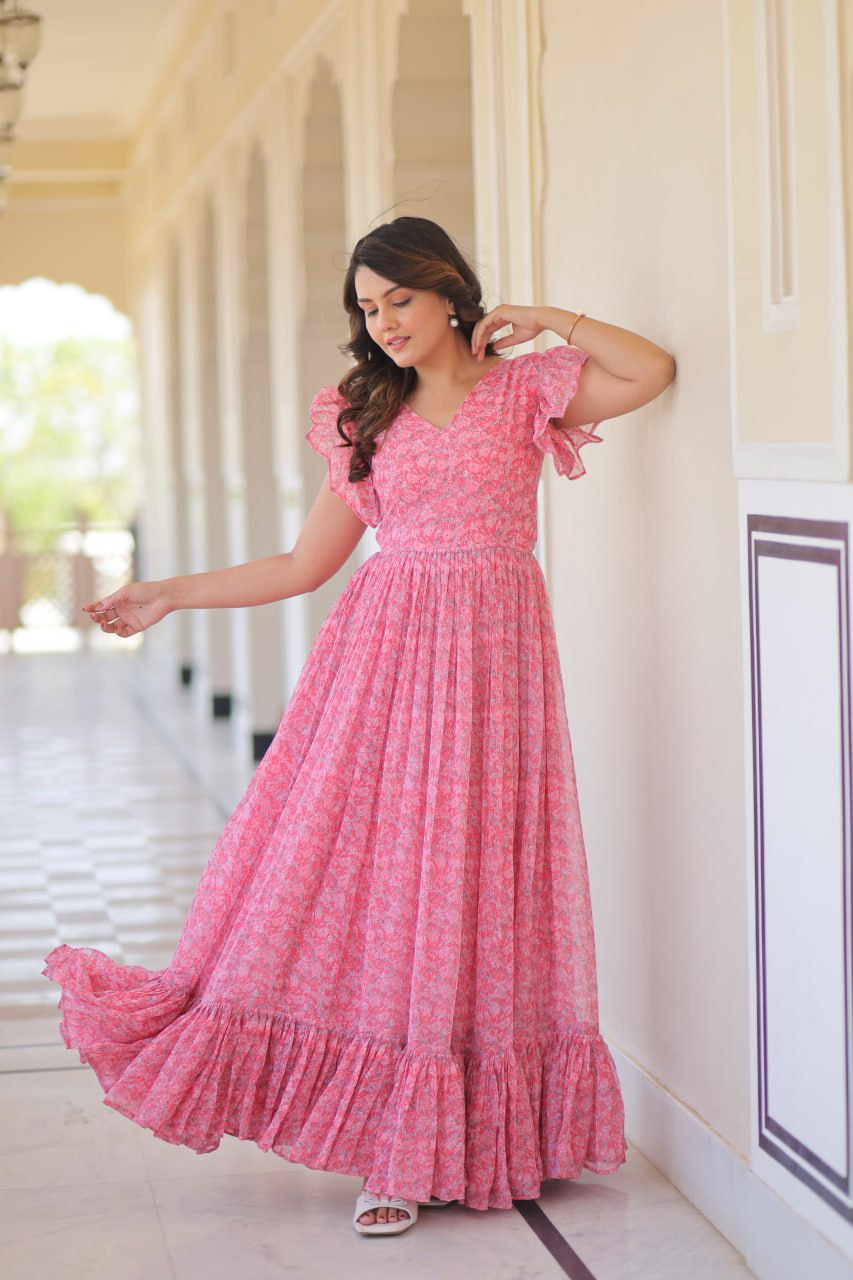 Printed pink georgette gown for women with 7-meter flair, bell sleeves & V-neck—lightweight ethnic dress for Haldi, Mehendi, Navratri & festive functions.