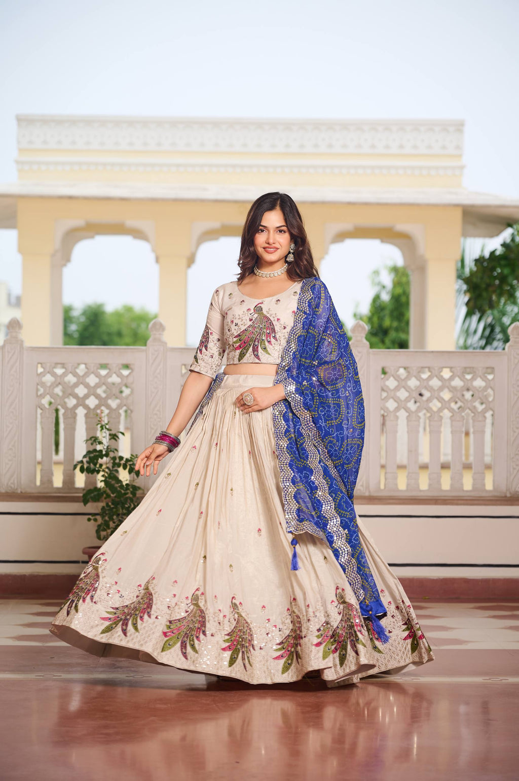 Amla off-white tissue silk lehenga choli with sequins thread work and blue Bandhej dupatta