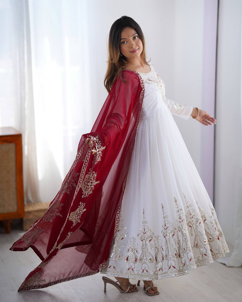 Tejvini White Embroidered Gown Set – heavy georgette gown with multi-thread 5mm sequin embroidery, full sleeves, soft cotton inner, paired with contrasting maroon embroidered dupatta and stitched bottom – ideal for weddings, receptions, and festive occasions.