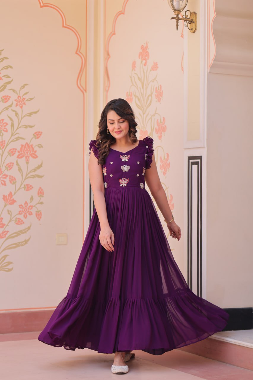 Lavi 7-meter flared designer gown in faux blooming fabric with sequin & bead embroidery, V-neck & frill shoulders – perfect for weddings & parties.