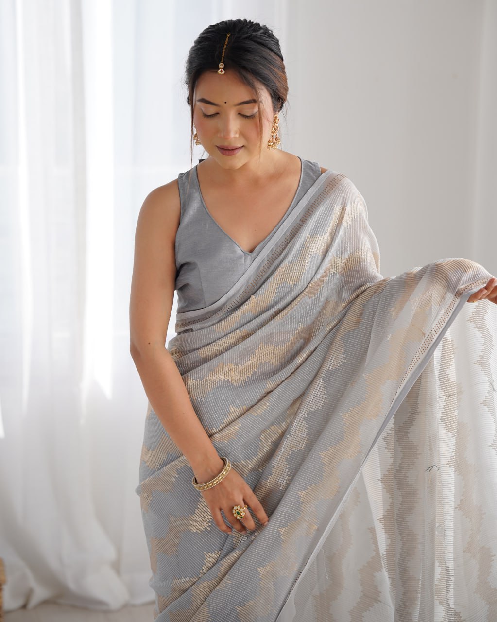 Graceful Aira Grey Georgette saree with heavy sequin embroidery and Seroski diamond embellishments, paired with an unstitched satin Banglori blouse – ideal bridal saree, festive saree, designer grey saree, elegant ethnic party wear, and luxury embroidered saree for women.
