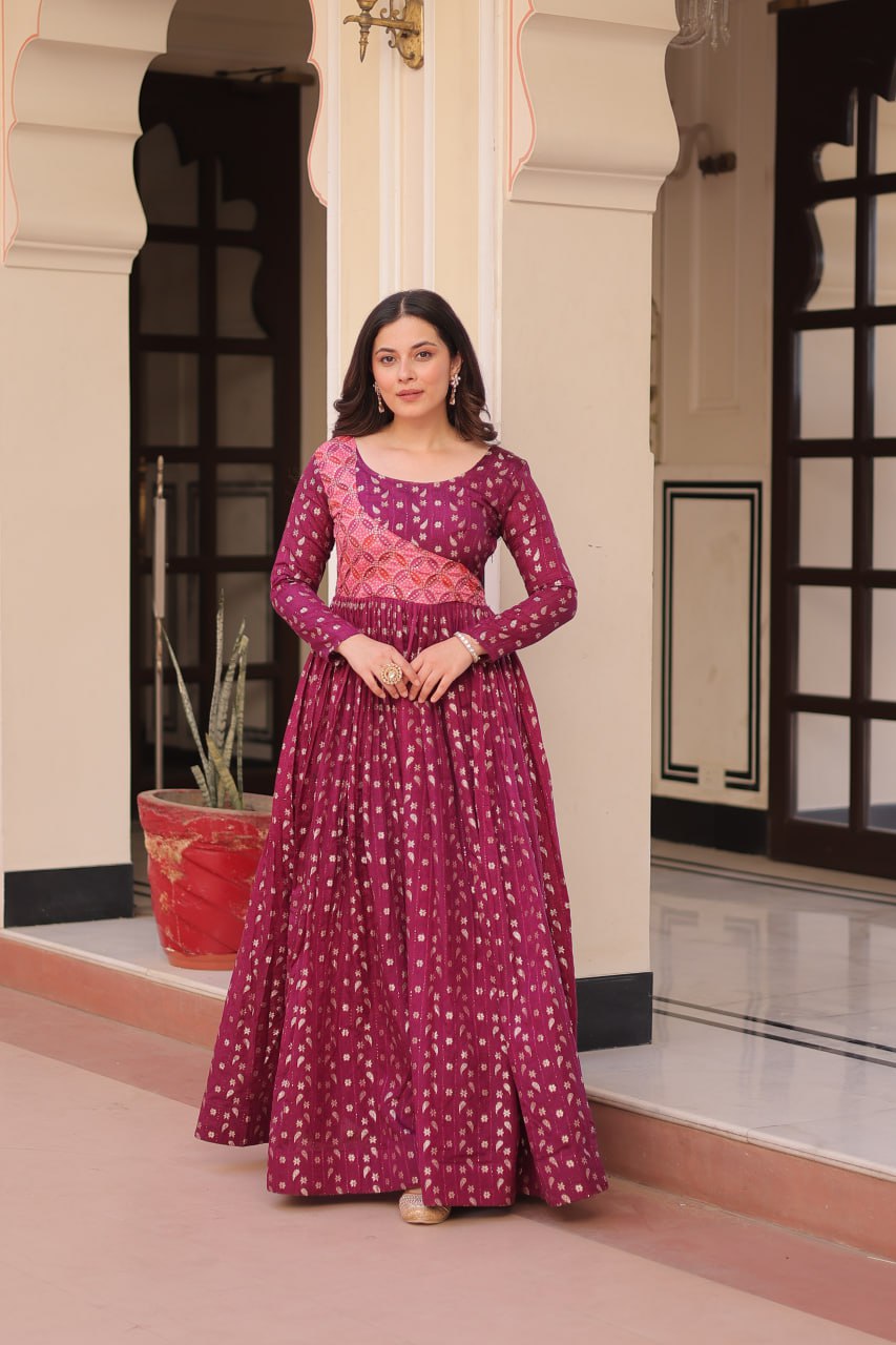 Vani Choli Printed Wine Color Gown with staple jacquard fabric, full sleeves, cotton lining, and 3-meter flare – perfect ethnic party wear gown for wedding functions, festive nights, and modern Indian women.