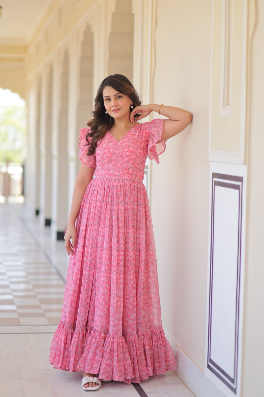 Printed pink georgette gown for women with 7-meter flair, bell sleeves & V-neck—lightweight ethnic dress for Haldi, Mehendi, Navratri & festive functions.