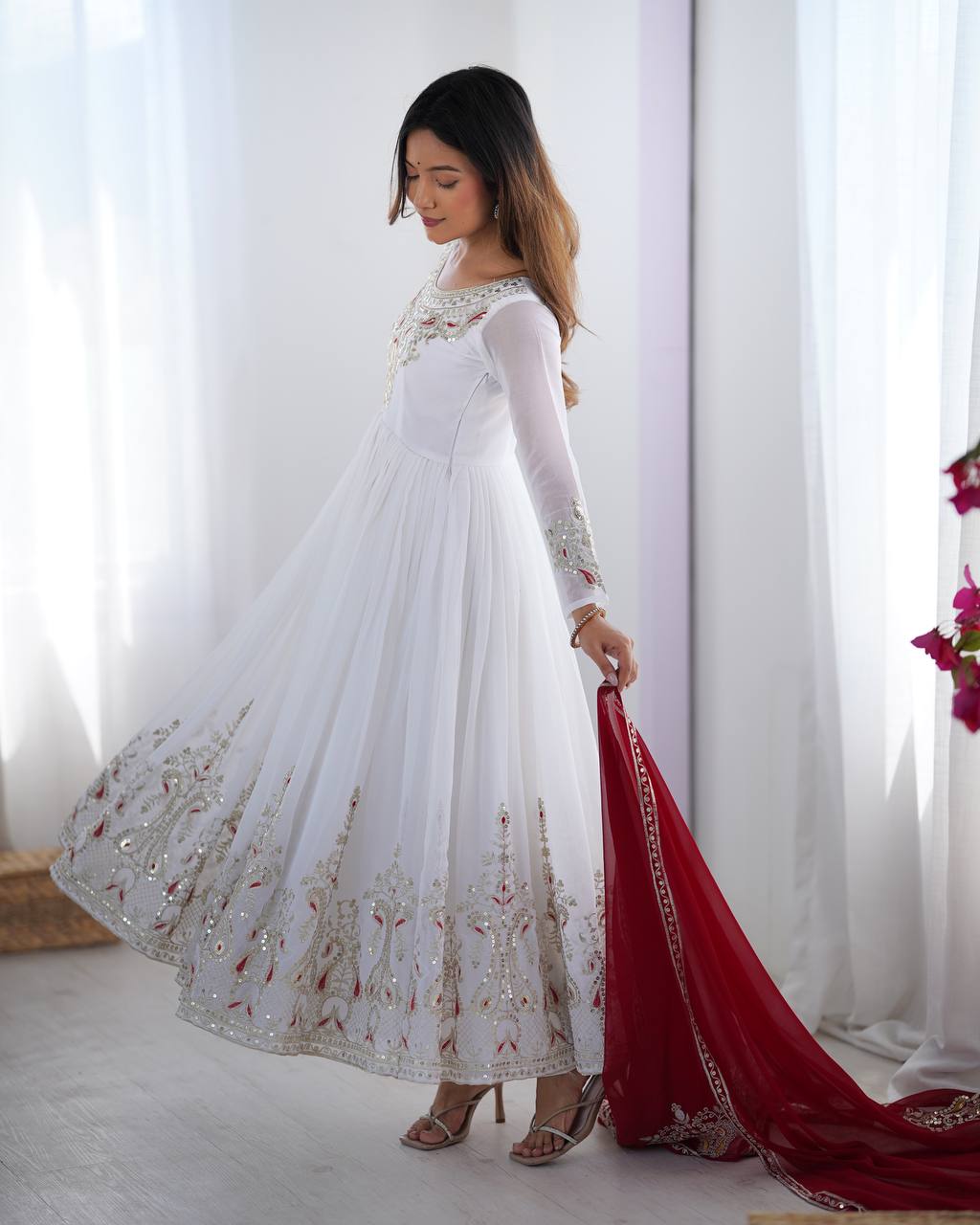 Tejvini White Embroidered Gown Set – heavy georgette gown with multi-thread 5mm sequin embroidery, full sleeves, soft cotton inner, paired with contrasting maroon embroidered dupatta and stitched bottom – ideal for weddings, receptions, and festive occasions.