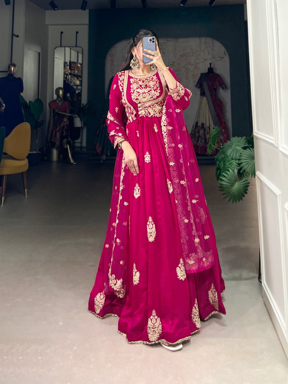 Anwitha Pink Embroidered Silk Anarkali Gown Set, crafted from luxurious Vichitra Silk with intricate sequins and thread embroidery accented by delicate lace details. This fully stitched Anarkali gown features a 3-meter flair and a soft cotton lining for comfort. Paired with a graceful net dupatta adorned with sequins embroidery and a lace border, this elegant ensemble is perfect for weddings, festive occasions, and grand celebrations