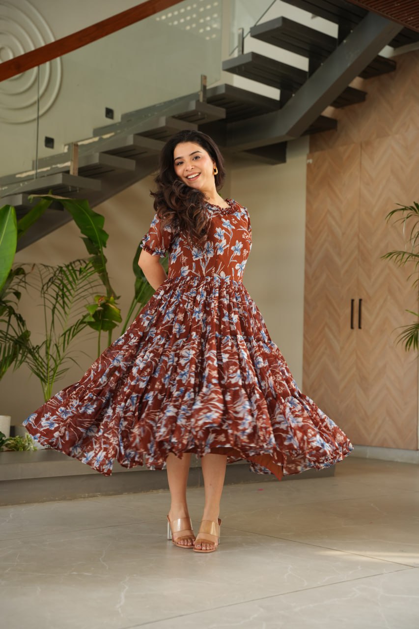 Vikarni Brown Printed Anarkali Gown in faux georgette with 12-meter flair & cotton lining – perfect for haldi, mehndi, festive & Indo-western occasions.