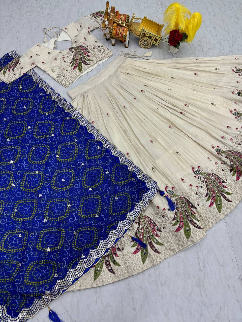 Amla off-white tissue silk lehenga choli with sequins thread work and blue Bandhej dupatta