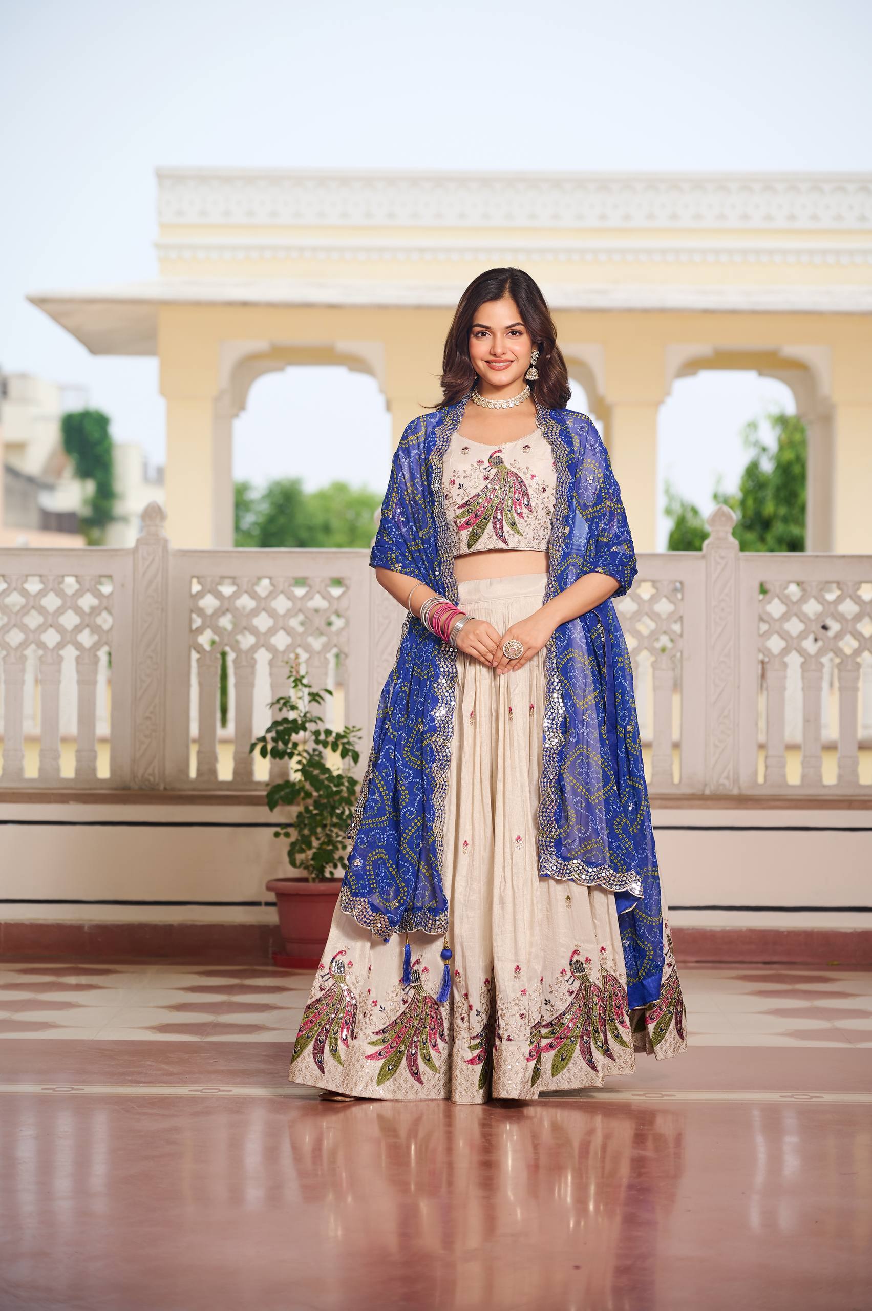 Amla off-white tissue silk lehenga choli with sequins thread work and blue Bandhej dupatta