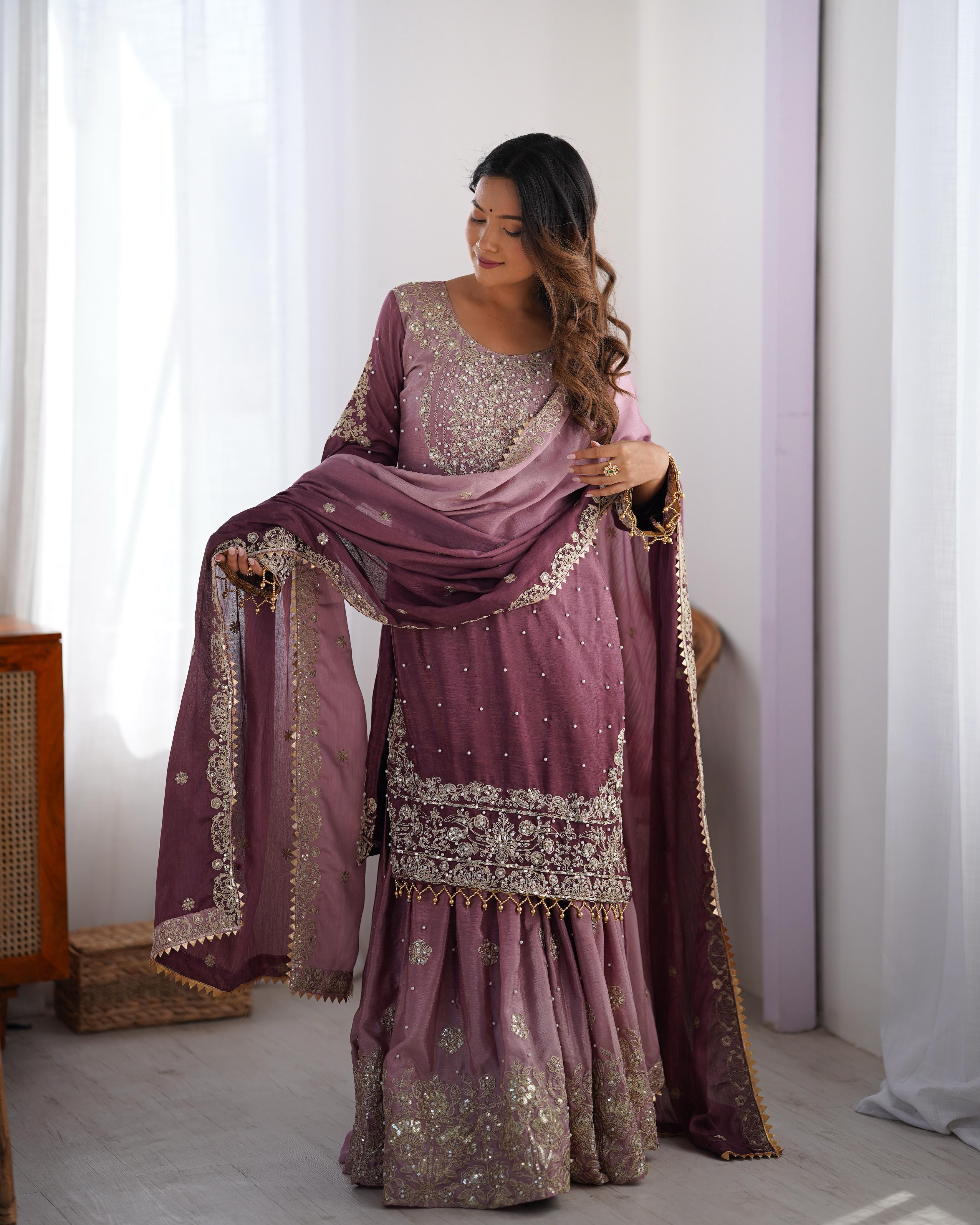 This Manvisha Pink Embroidered Sharara Suit Set is a premium choice for wedding wear, partywear sharara suits, and festive ethnic outfits. Made from luxurious Chinon silk, this designer sharara set features intricate cording dori embroidery, sequins work, and rivet moti detailing, making it perfect for Indian wedding outfits. The fully stitched kurta showcases embroidery on both the front and back, complementing the stylish embroidered sharara pants with an elastic waistband for a comfortable fit. Paired wi