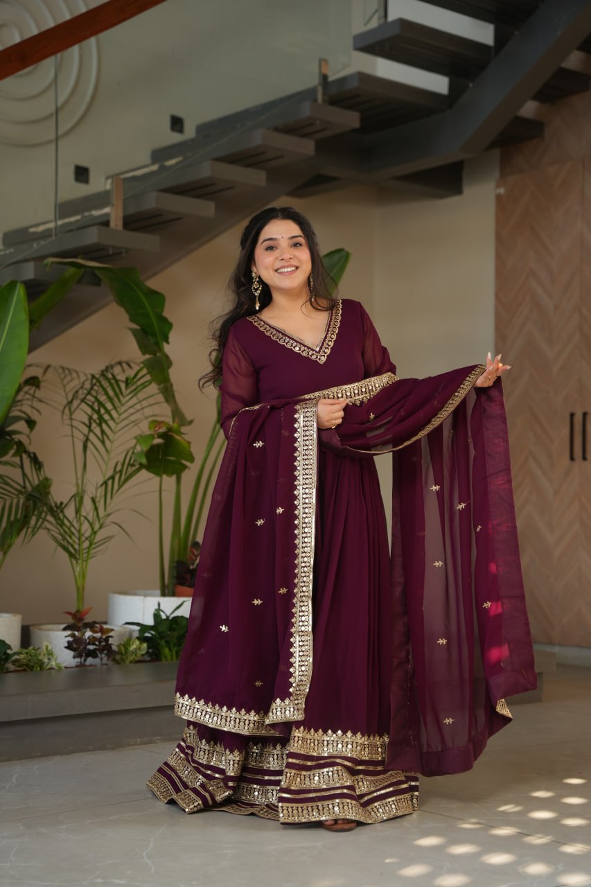 Sampriti Wine Embroidered Gown Set – wine color gown with dupatta, zari sequin ethnic gown, faux blooming fabric gown for women, V-neck partywear gown, wedding guest long gown, Indian embroidered gown dress, full sleeve flair gown, bridal festive ethnic outfit, designer wine Anarkali gown, fully stitched traditional gown.