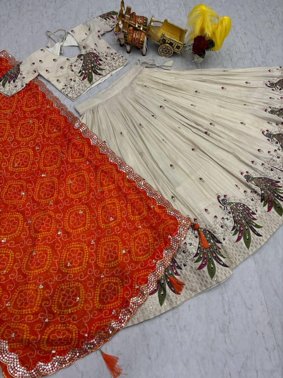 Amla off-white tissue silk lehenga choli with sequins thread work and orange Bandhej dupatta