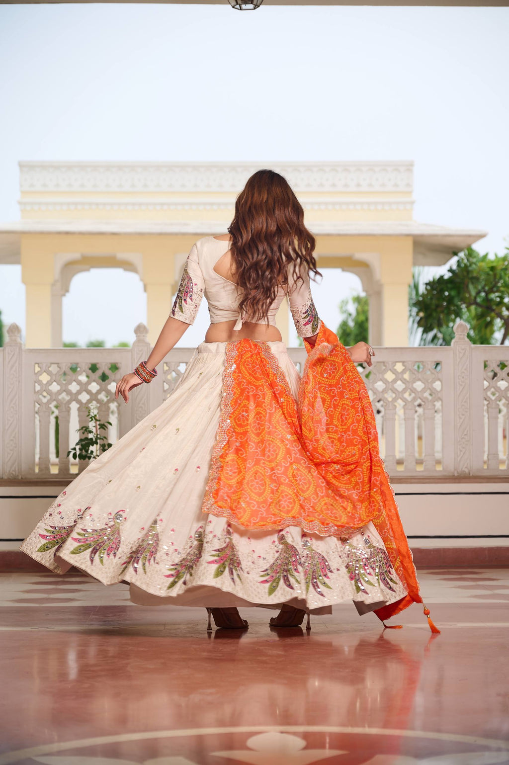 Amla off-white tissue silk lehenga choli with sequins thread work and orange Bandhej dupatta